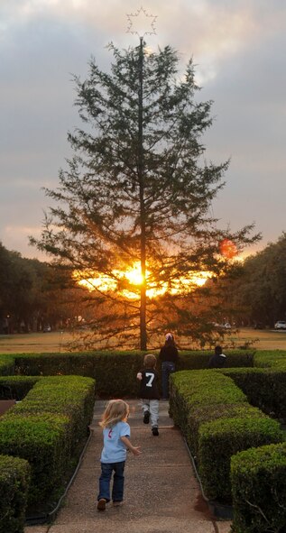 Team Barksdale children run to gather around the Christmas tree before the annual Holiday tree lighting ceremony on Barksdale Air Force Base, La., Dec. 6. More than 100 members of Team Barksdale gathered to watch the lighting ceremony and visit with Santa. (U.S. Air Force photo/Senior Airman Kristin High)