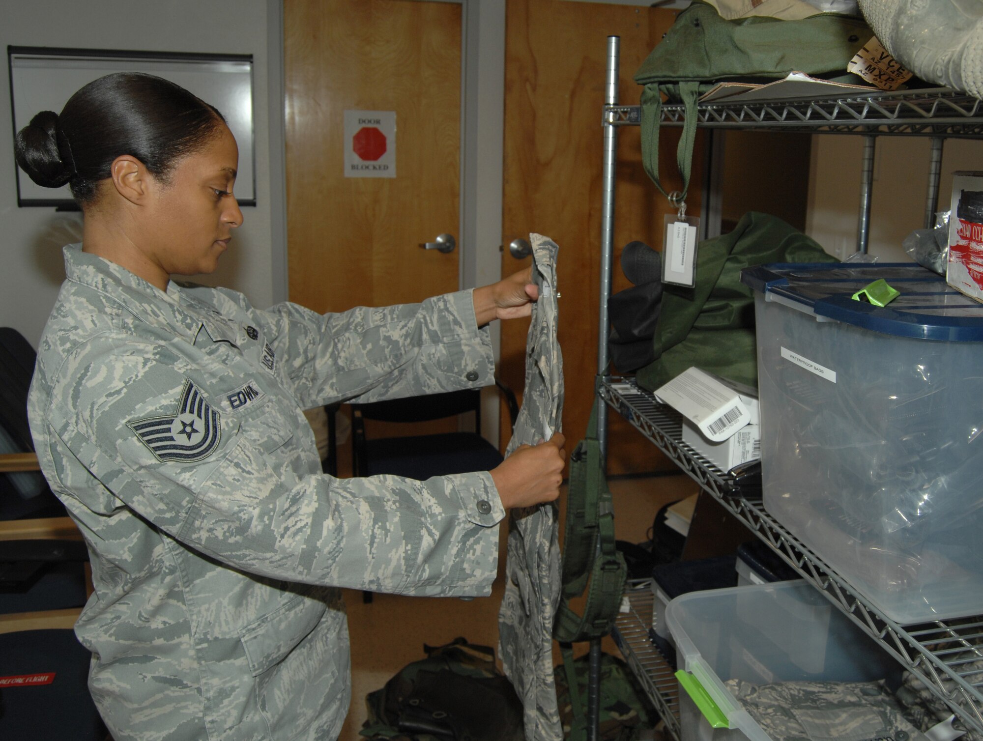 U.S. Air Force Tech. Sgt. Sheena Edwards, 355th Medical Support Squadron noncommissioned officer in charge of medical readiness, inspects equipment used for deploying Airmen at Davis-Monthan Air Force Base, Ariz., Nov. 27, 2012. (U.S. Air Force photo by Senior Airman Michael Washburn/Released)