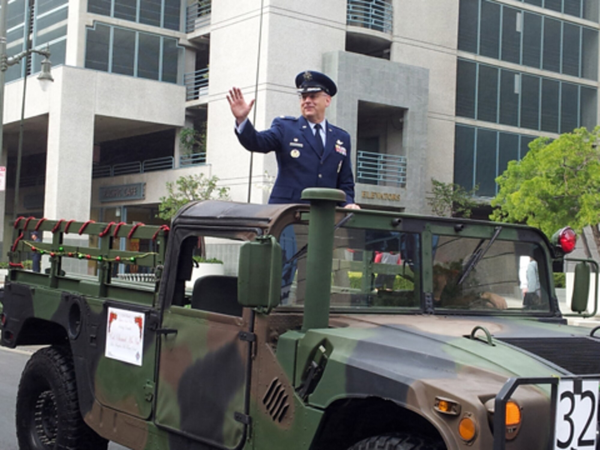 Colonel Sam McNiel, 61st Air Base Group commander, waves to the crowd during the San Pedro Holiday Parade, Dec. 2. The annual parade kicks off the holiday season in San Pedro. (Photo by Madlyn Washington)
