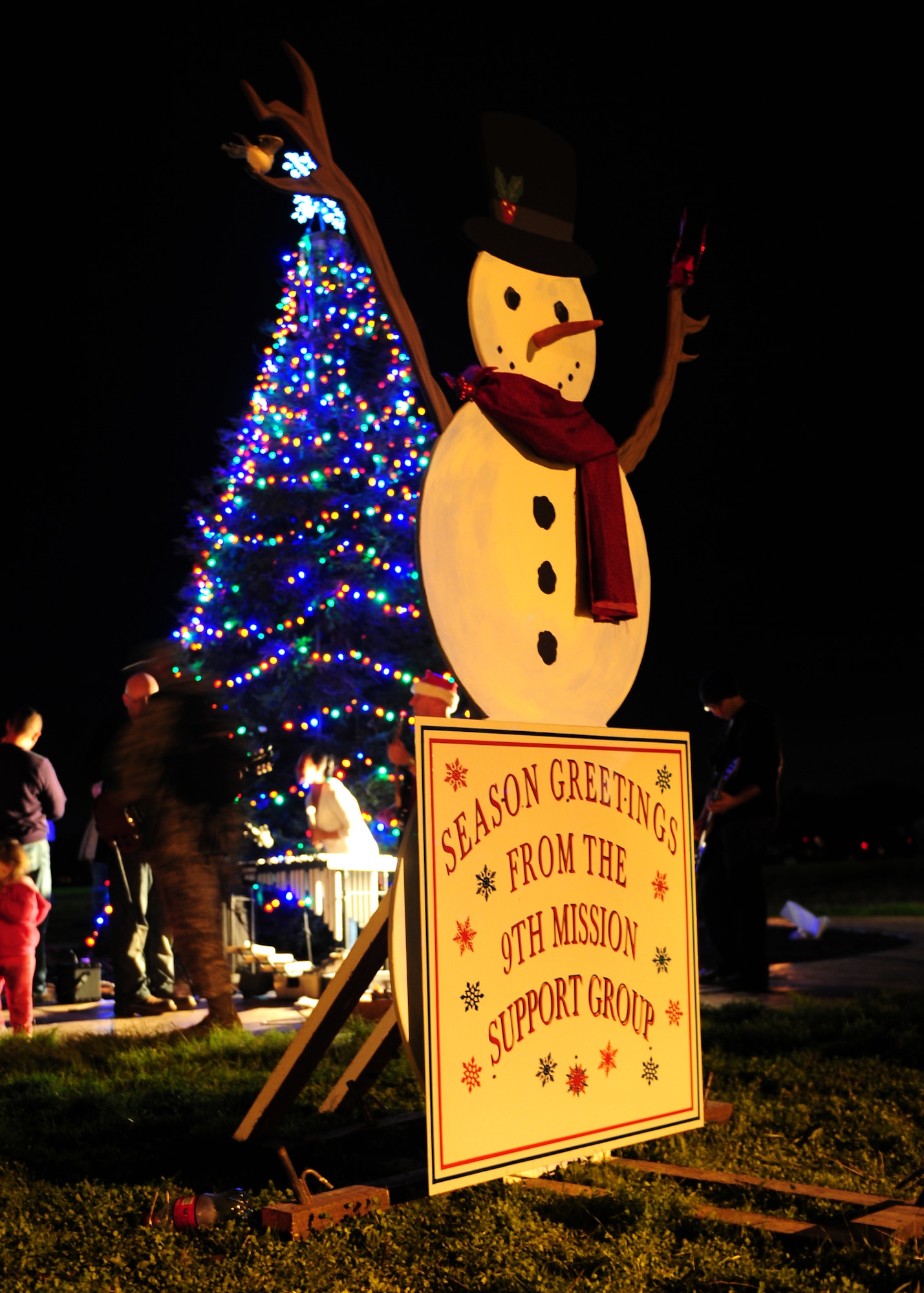 A large holiday greeting card stands in front of the Beale Air Force Base Christmas Tree during the Hearts Apart Dinner and tree lighting Dec. 7, 2012. The 9th Civil Engineer and 9th Force Support squadrons together with Beale’s first sergeants, Blue Star Moms, and volunteers from the base hosted the tree lighting for the base populace and the Hearts Apart Dinner for spouses and families of deployed Airmen. (U.S. Air Force photo by Senior Airman Shawn Nickel/Released)