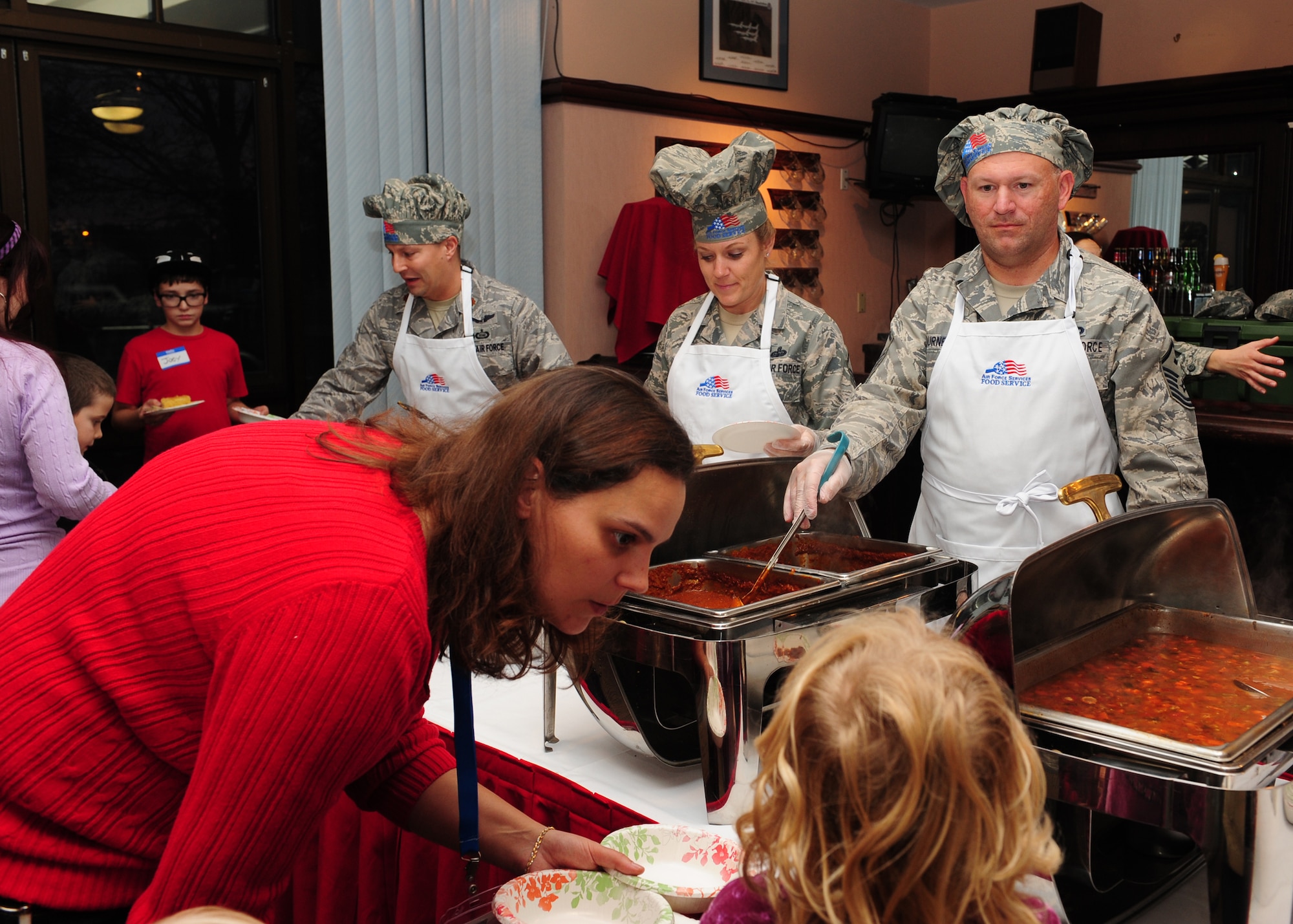 First sergeants serve chili and soup at the Hearts Apart Dinner Dec. 7, 2012, at Beale Air Force Base, Calif. Leadership from several squadrons attended to answer questions while Beale’s first sergeants served during the event for families of deployed Airmen. (U.S. Air Force photo by Senior Airman Shawn Nickel/Released)