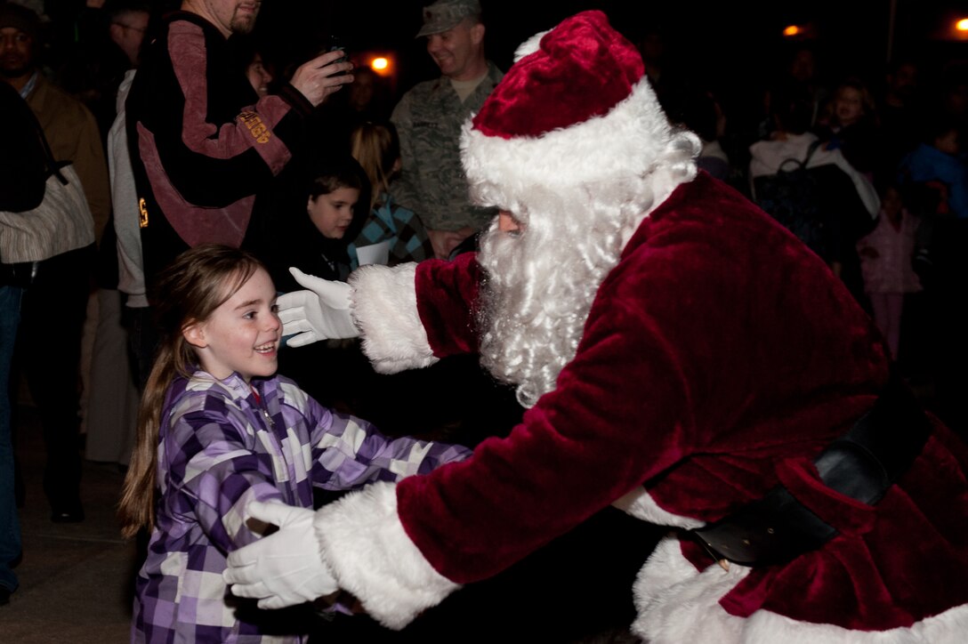 Santa Claus hugs Anne, six-year-old daughter of Maj. Matthew Reese, 28th Bomb Wing public affairs officer, during the 28th Bomb Wing Tree Lighting Ceremony in front of the Freedom Chapel on Ellsworth Air Force Base, S.D, Dec. 5, 2012. This annual event kicks off the holiday season with holiday singing, and a visit from Santa Claus. (U.S. Air Force photo by Airman 1st Class Kate Thornton-Maurer/Released)