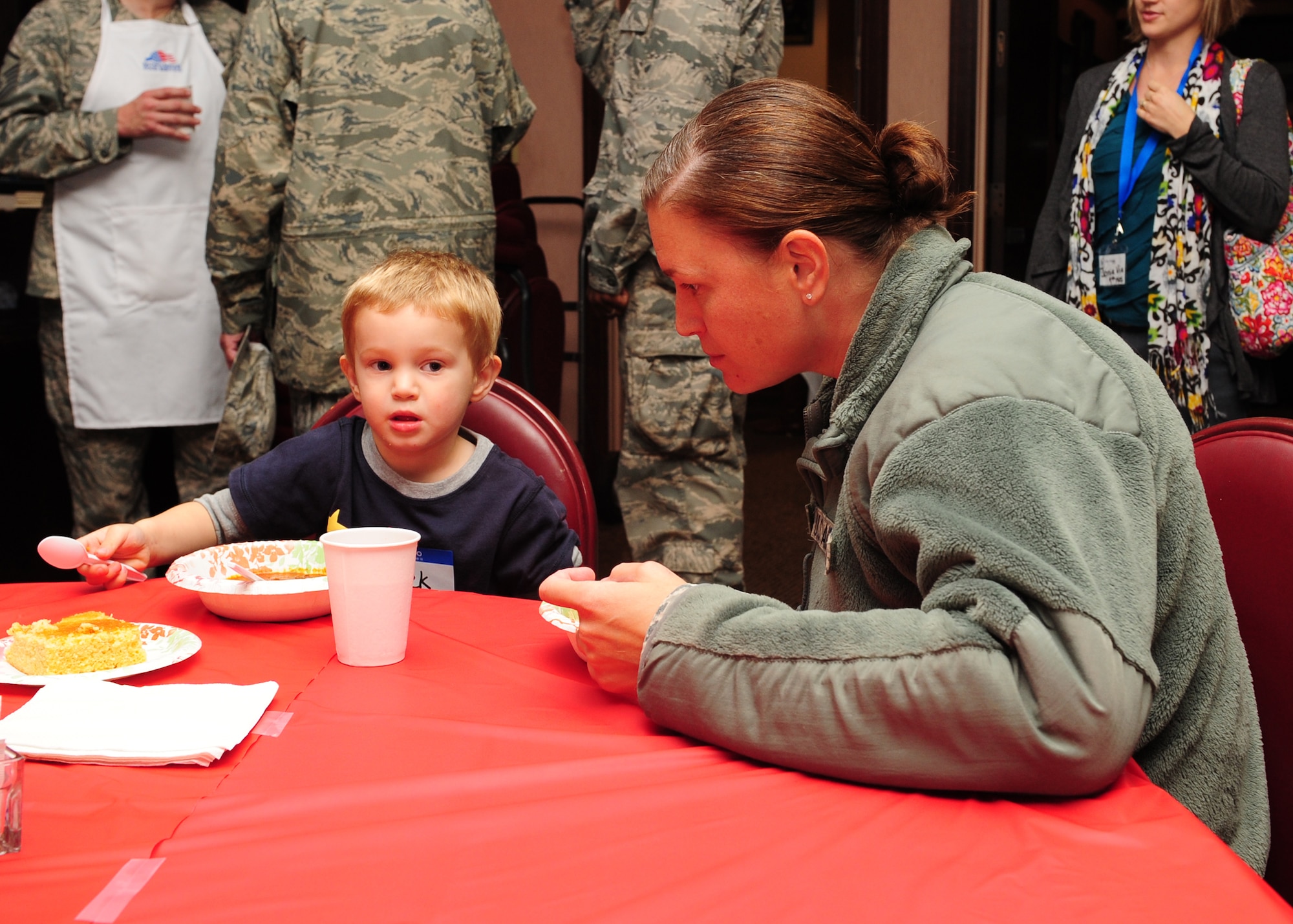 Capt. Christianne Opresko, 9th Physiological Support Squadron physiologist, eats with her son at the Hearts Apart Dinner Dec. 7, 2012. Families of deployed Airmen got together for a night of food, fun, festivities and prizes. (U.S. Air Force photo by Senior Airman Shawn Nickel/Released)