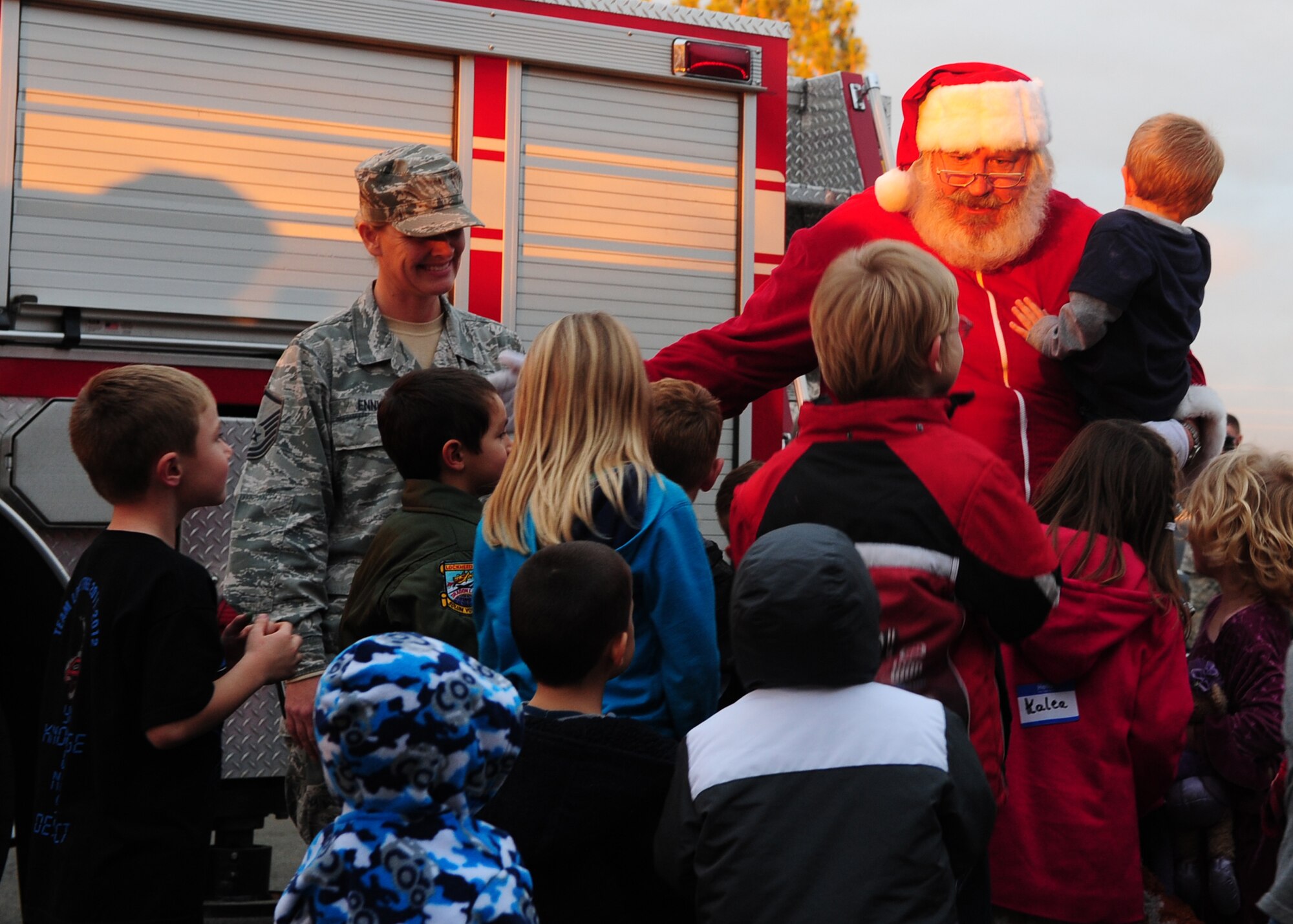Santa Claus is greeted by children from Beale Air Force Base, Calif., after he arrived on a fire engine to the Hearts Apart Dinner and tree lighting Dec. 7, 2012. The 9th Civil Engineer and 9th Force Support squadrons together with Beale’s first sergeants, Blue Star Moms, and volunteers from the base hosted the tree lighting for the base populace and the Hearts Apart Dinner for spouses and families of deployed Airmen. (U.S. Air Force photo by Senior Airman Shawn Nickel/Released)