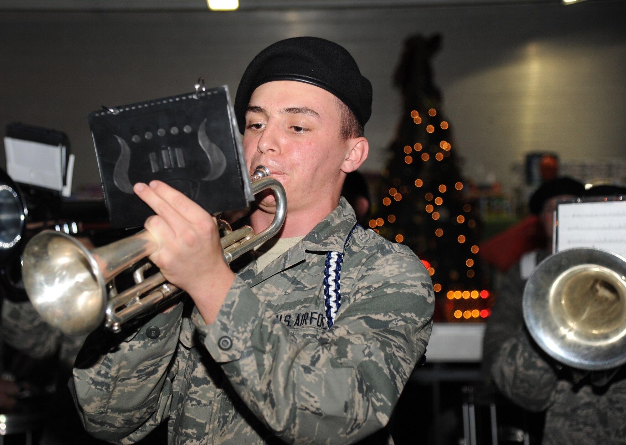 Airman Basic Justin Hutchings, 336th Training Squadron, plays the trumpet with Keesler’s Drum and Bugle Corps as they play a selection of holiday music during Keesler’s annual Holiday in the Park, Dec. 6, 2012, at marina park, Keesler Air Force Base, Miss. The event also included a tree lighting ceremony, hay rides, holiday music sung by the audience, visits with Santa and free food and beverages.  (U.S. Air Force photo by Kemberly Groue)