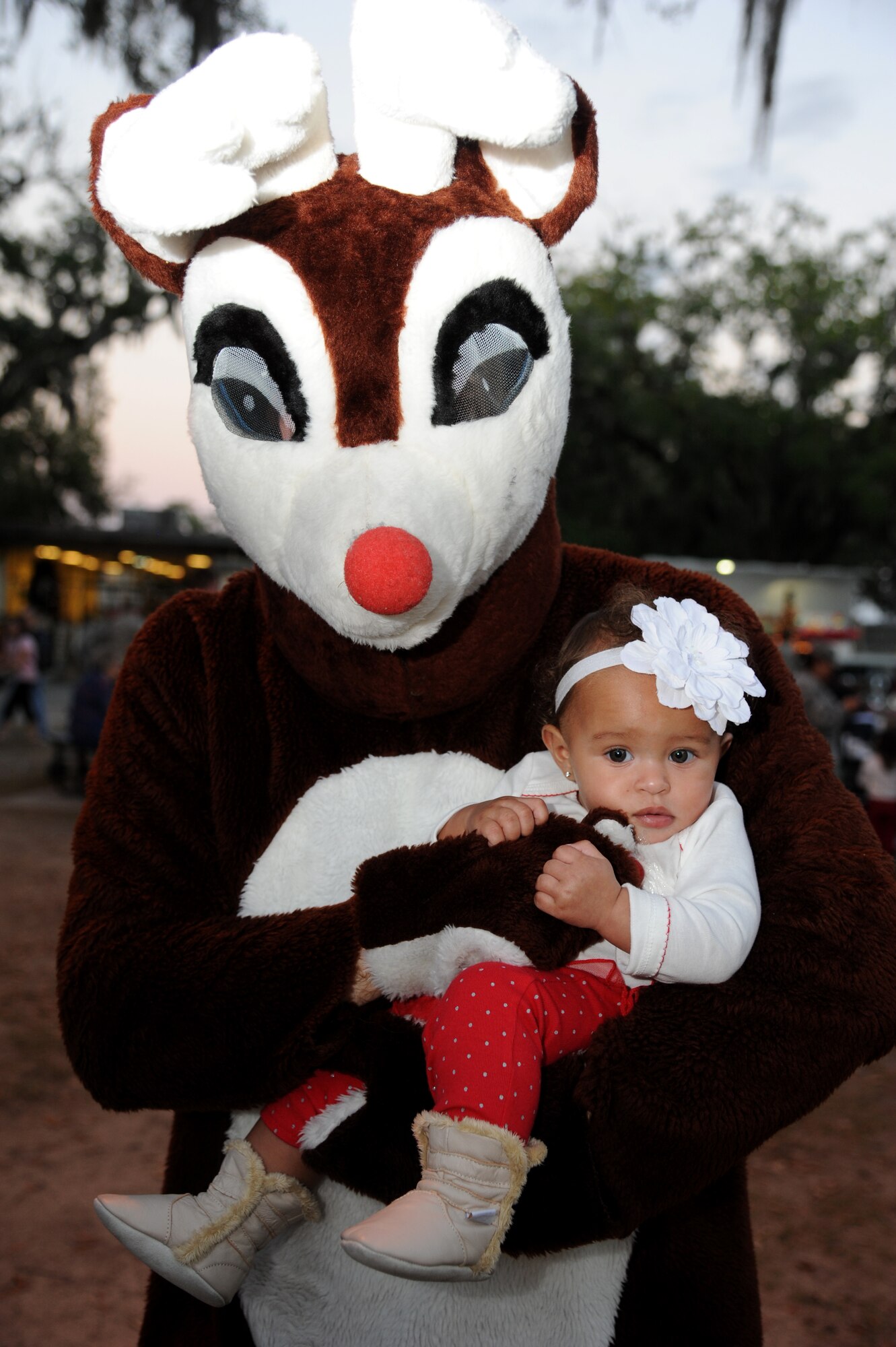 Rudolph, the red nose reindeer, holds Layla Freeman, 8 months, daughter of Airmen 1st Class Holly and Kenneth Freeman, 81st Medical Support Squadron, during Keesler’s annual Holiday in the Park, Dec. 6, 2012, at marina park, Keesler Air Force Base, Miss. The event included a tree lighting ceremony, hay rides, holiday music, visits with Santa and free food and beverages.  (U.S. Air Force photo by Kemberly Groue)