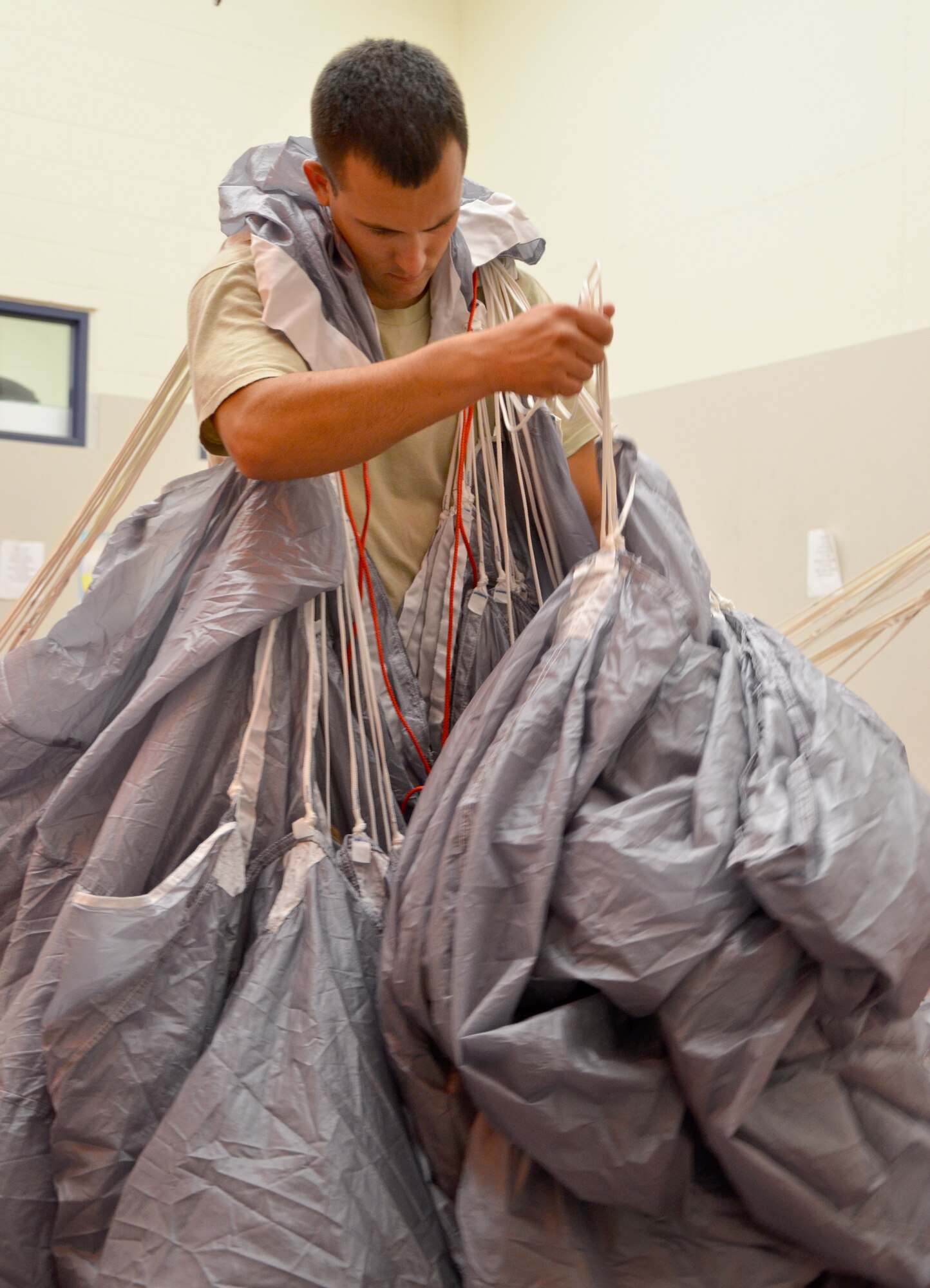 Tech. Sgt. Brian Pajor, a parachute rigger for the 920th Rescue Wing, Patrick Air Force, Base, Fla., carefully packs a pararescueman?s parachute for pararescuemen for a skydiving exercise July 19, 2012 in Comox, Canada. Airmen from the 920th Rescue Wing, Air Force Reserve?s only search-and-rescue wing, trained with Canadian search-and-rescue personnel to learn from one another and build strong working relationships. (U.S. Air Force photo/Staff Sgt. Anna-Marie Wyant)
