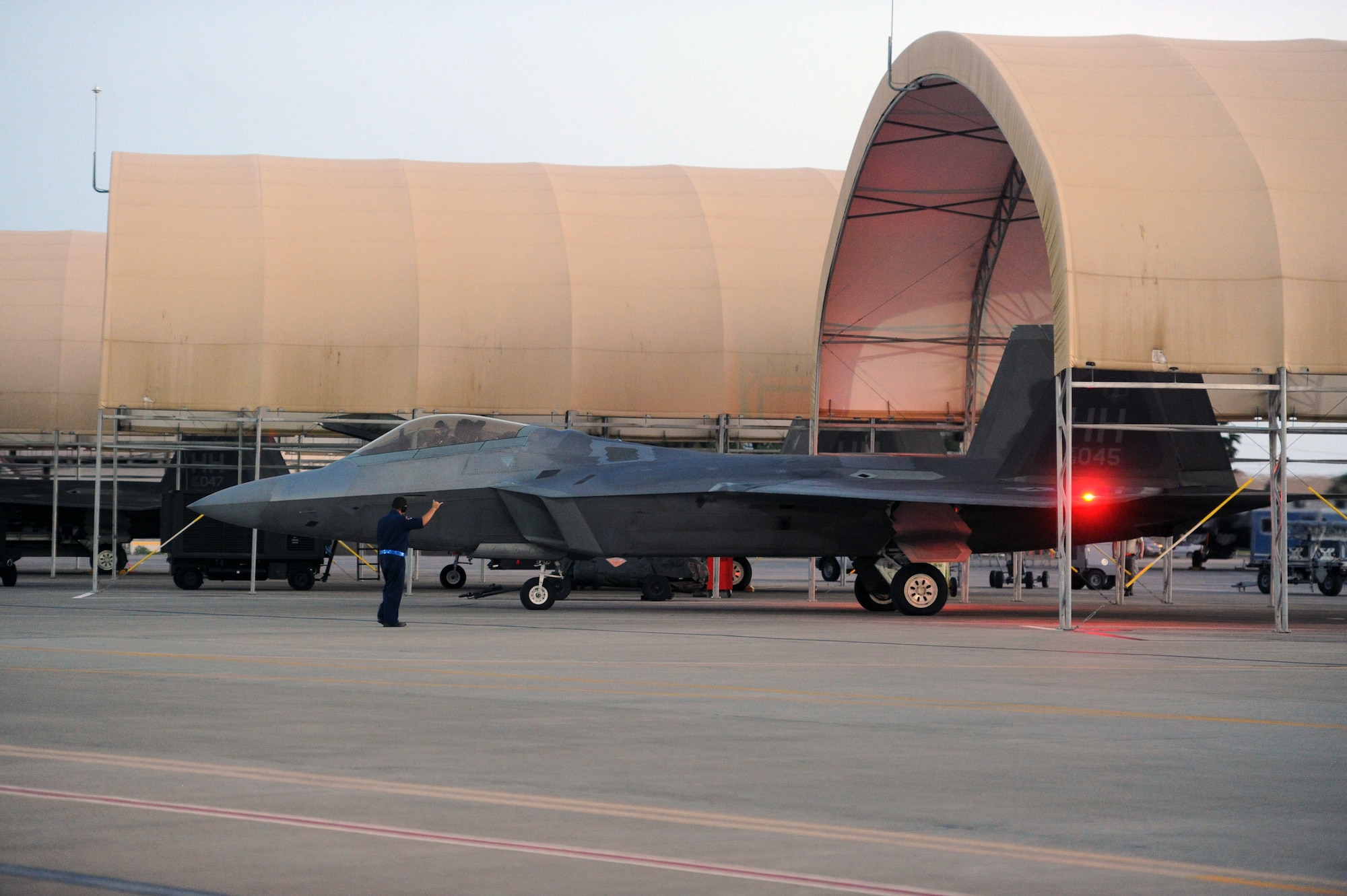 An F-22 Raptor taxis to the "Alert Pad" Dec. 6 at Joint Base Pearl Harbor-Hickam, Hawaii. The active duty 19th Fighter Squadron, in partnership with the Hawaii Air National Guard's 199th Fighter Squadron, took over the Aerospace Control Alert mission from the Montana Air National Guard, who have operated the mission for the past two years during a transition from the F-15 Eagle to the F-22. (U.S. Air Force photo by Staff Sgt. Nathan Allen)