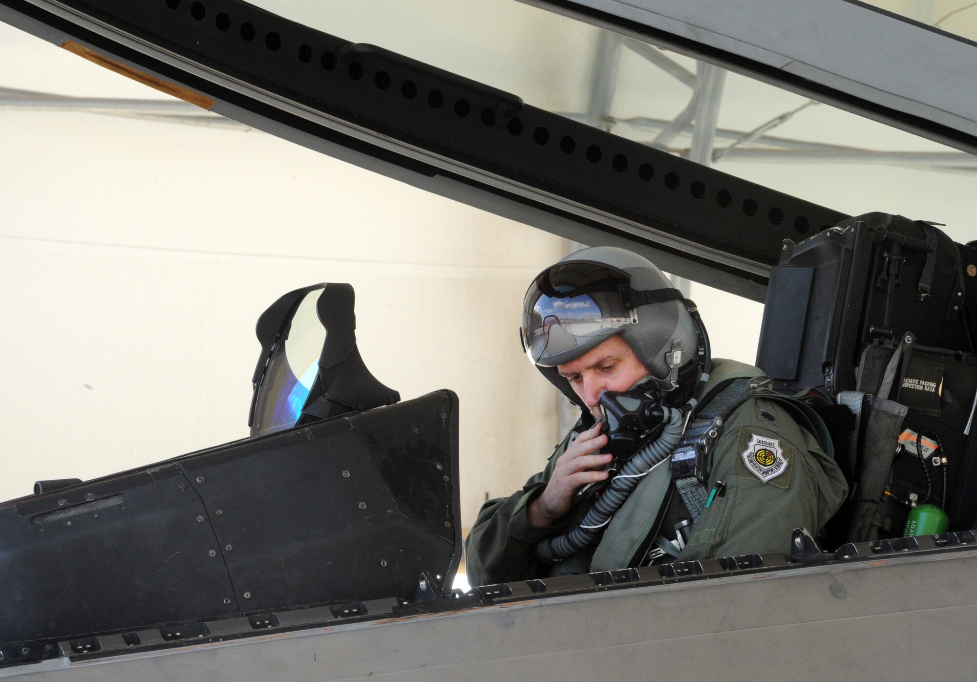 Lt. Col. Robert Jackson, 19th Fighter Squadron commander, sits in the pilot seat of an F-22 Raptor Dec. 6 at Joint Base Pearl Harbor-Hickam, Hawaii. The active duty 19th FS, in partnership with the Hawaii Air National Guard's 199th Fighter Squadron, took over the Aerospace Control Alert mission from the Montana Air National Guard, who have operated the mission for the past two years during a transition from the F-15 Eagle to the F-22. (U.S. Air Force photo by Staff Sgt. Nathan Allen)