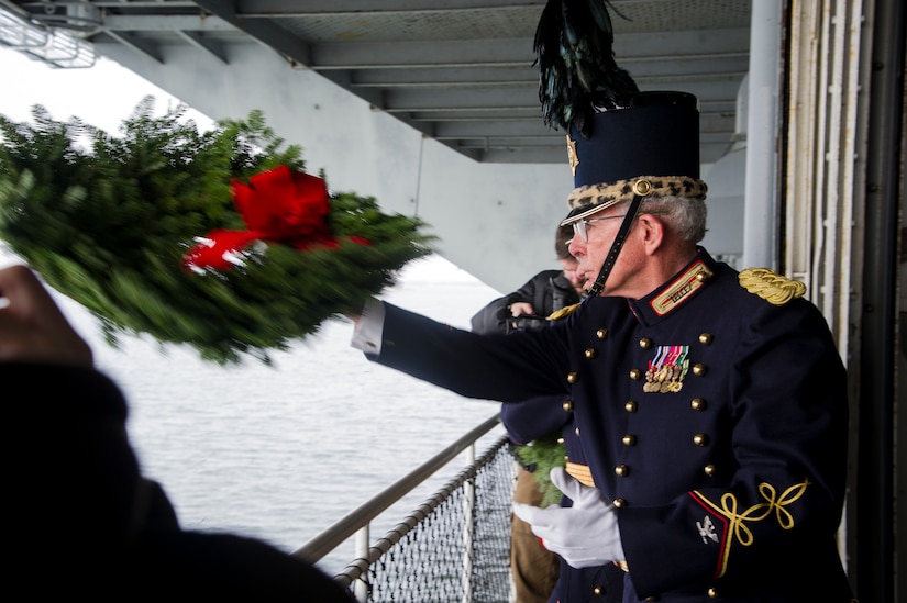 A veteran tosses a wreath into Charleston Harbor from USS Yorktown (CV 10) during the Pearl Harbor 71st Anniversary Memorial Service Dec. 7, 2012, at the Patriots Point Naval and Maritime Museum, Mount Pleasant, S.C. Tossing a wreath into the sea has been a time-honored  Naval tradition symbolizing burial at sea. The ceremony was held in honor of the 25 known men from South Carolina who gave their lives during the Dec. 7, 1941, Japanese attack on Pearl Harbor and other military installations. (U.S. Air Force photo/Staff Sgt. Rasheen Douglas)