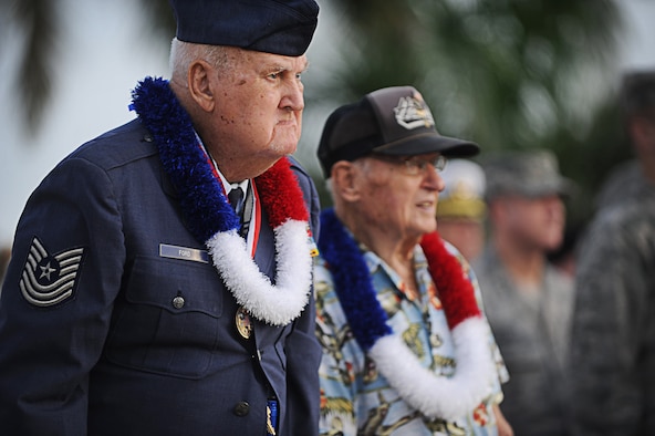 Two Hickam Field survivors, Master Sgt. (Ret.) Kenneth Ford and Col. (Ret.) Andrew Kowalski, stand for the invocation Dec. 7 during the 71st anniversary ceremony commemorating the 1941 attacks on Hickam Field. Ford and Kowalski were both enlisted in the Army Air Corps during the attacks. Ford was given a rifle and five rounds to defend the beach from another wave of attacks.  Kowalski reported to the Wing Headquarters building and fielded calls reporting the names and numbers of casualties. (U.S. Air Force photo/Senior Airman Lauren Main)