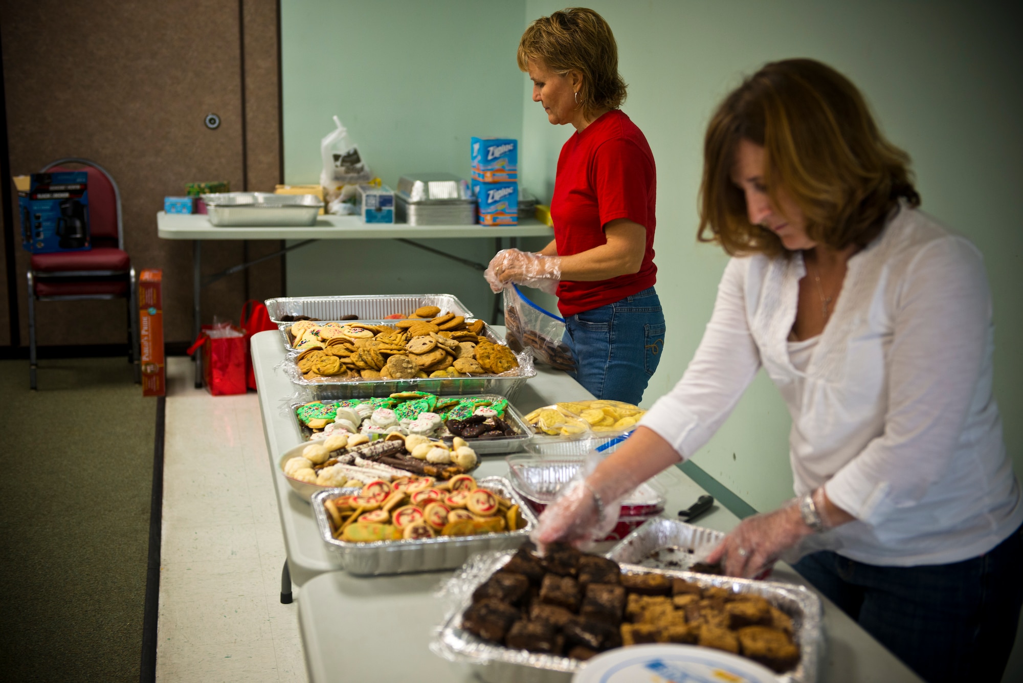 Kim Franks, right, wife of U.S. Air Force Col. Chad Franks, and Monica Maruyama, wife of Lt. Col. Daniel Maruyama, prepare to bag cookies at Moody Air Force Base, Ga., Dec. 3, 2012. Local schools and community members showed their appreciation for Moody Airmen by decorating bags and donating cookies. (U.S. Air Force photo by Senior Airman Douglas Ellis/Released) 
