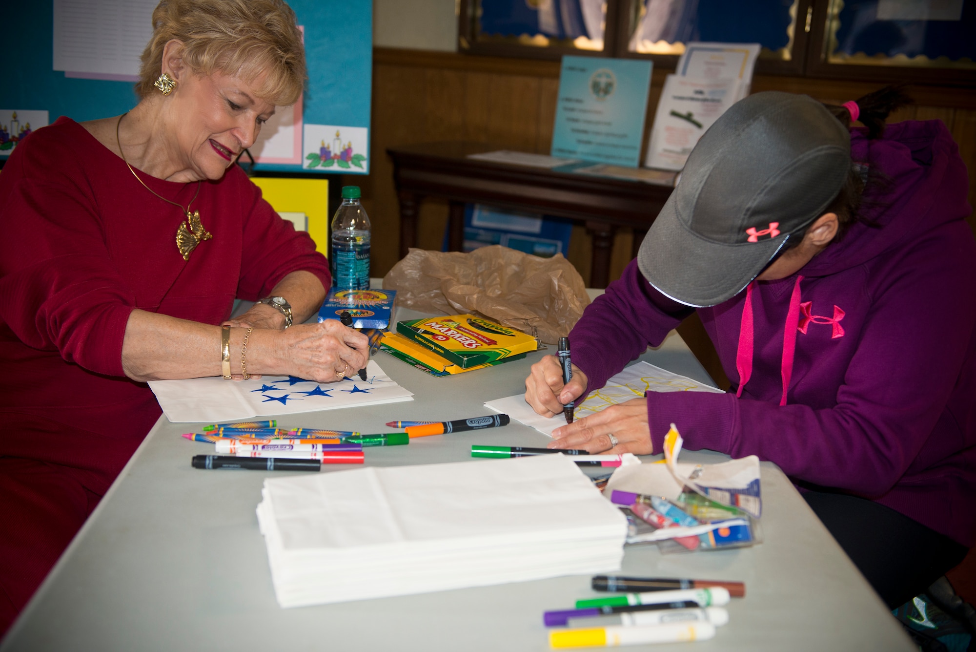 Dr. Lucy Greene, Moody Support Committee, and U.S. Air Force Staff Sgt. Vanessa Thomas, 23d Wing protocol NCO in charge, decorate goody-bags at Moody Air Force Base, Ga., Dec. 3, 2012. The bags were used for the Annual Moody Airmen Cookie Drive. (U.S. Air Force photo by Senior Airman Douglas Ellis/Released)
