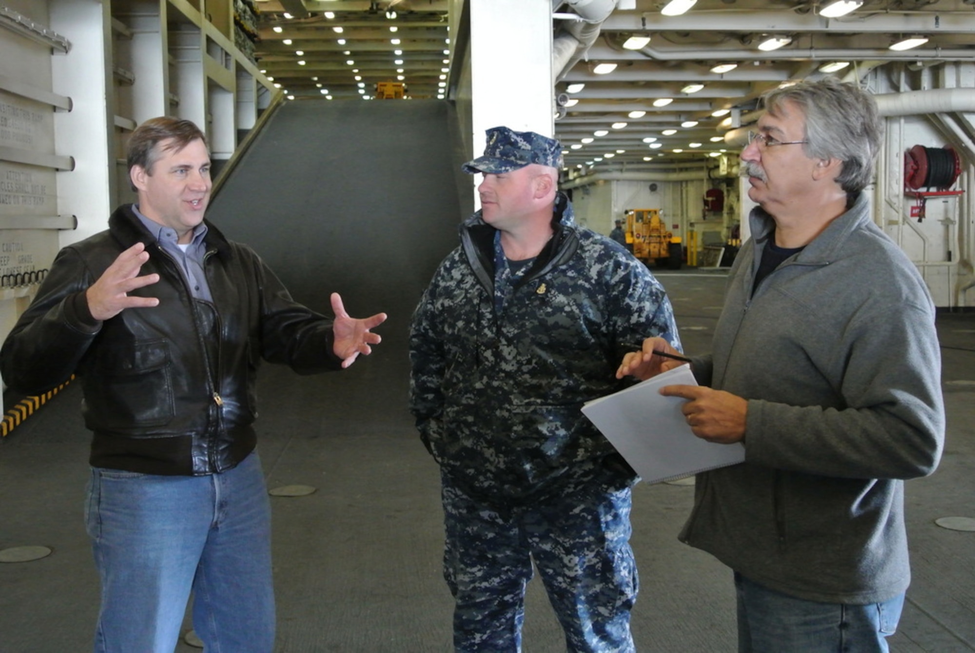 Andy Quiett, 45th Operations Group, Detachment 3, discusses astronaut recovery procedures with US Navy and NASA personnel aboard the USS Mesa Verde, 29 November 2012.
