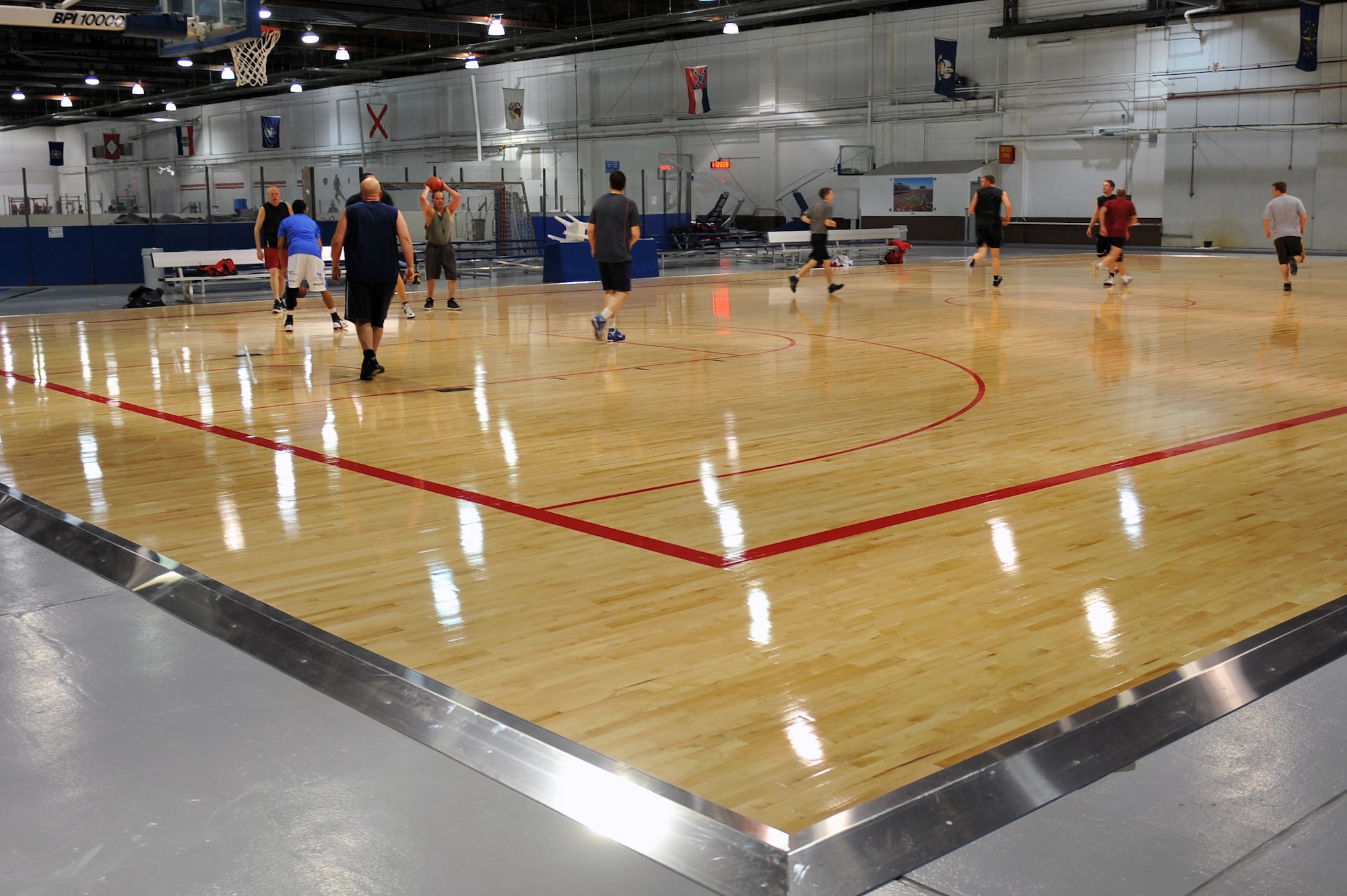 Patrons enjoy a newly renovated basketball court at the Offutt Field House on Offutt Air Force Base, Neb., Dec. 6. The field house is currently undergoing major renovations to improve the basketball courts and soccer field. One basketball court is complete and another is currently being renovated along with the nearby soccer field turf. (U.S. Air Force photo by Jeff W. Gates/Released)