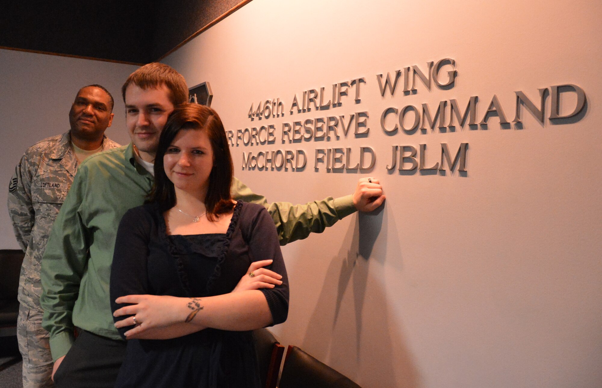 Eric (center) and Ashlee Todd after taking their oath of enlistment with the Air Force Reserve at the 446th Airlift Wing headquarters building at McChord Field, Wash., Nov. 30, 2012. Originally, Ashlee was going to be the only enlistee, but thanks to Master Sgt. Charles Loftland (left), a recruiter for the 446th AW, Eric was sold on the honor of joining the Reserve with his wife. (U.S. Air Force photo by Master Sgt. Jake Chappelle)