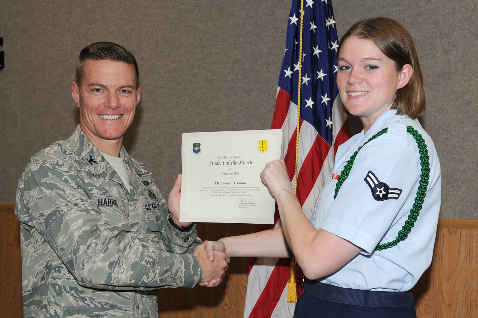 U.S. Air Force Col. Brendan Harris, 17th Training Group commander, presents Airman 1st Class Shana Cannon with the 315th Training Squadron Enlisted Student of the Month award for November at Goodfellow Air Force Base, Texas, Dec. 7, 2012. (U.S. Air Force photo by Staff Sgt. Laura R. McFarlane)
