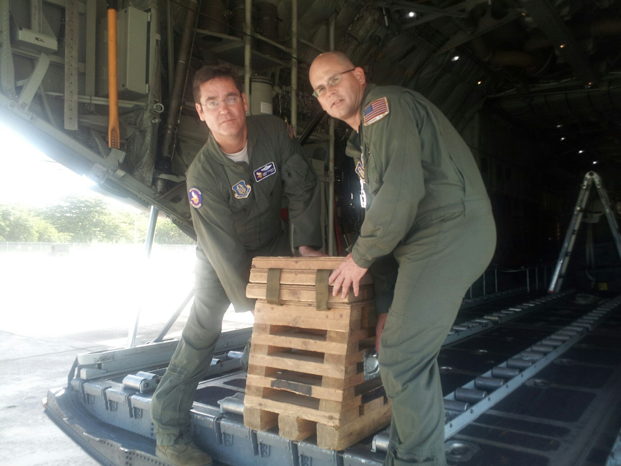 Master Sgts. Jim Courneya (left) and Eric Schraeder, 96th Airlift Squadron, prepare for a sortie during their Coronet Oak deployment to Muniz Air National Guard Base, San Juan, Puerto Rico. (Air Force Photo)