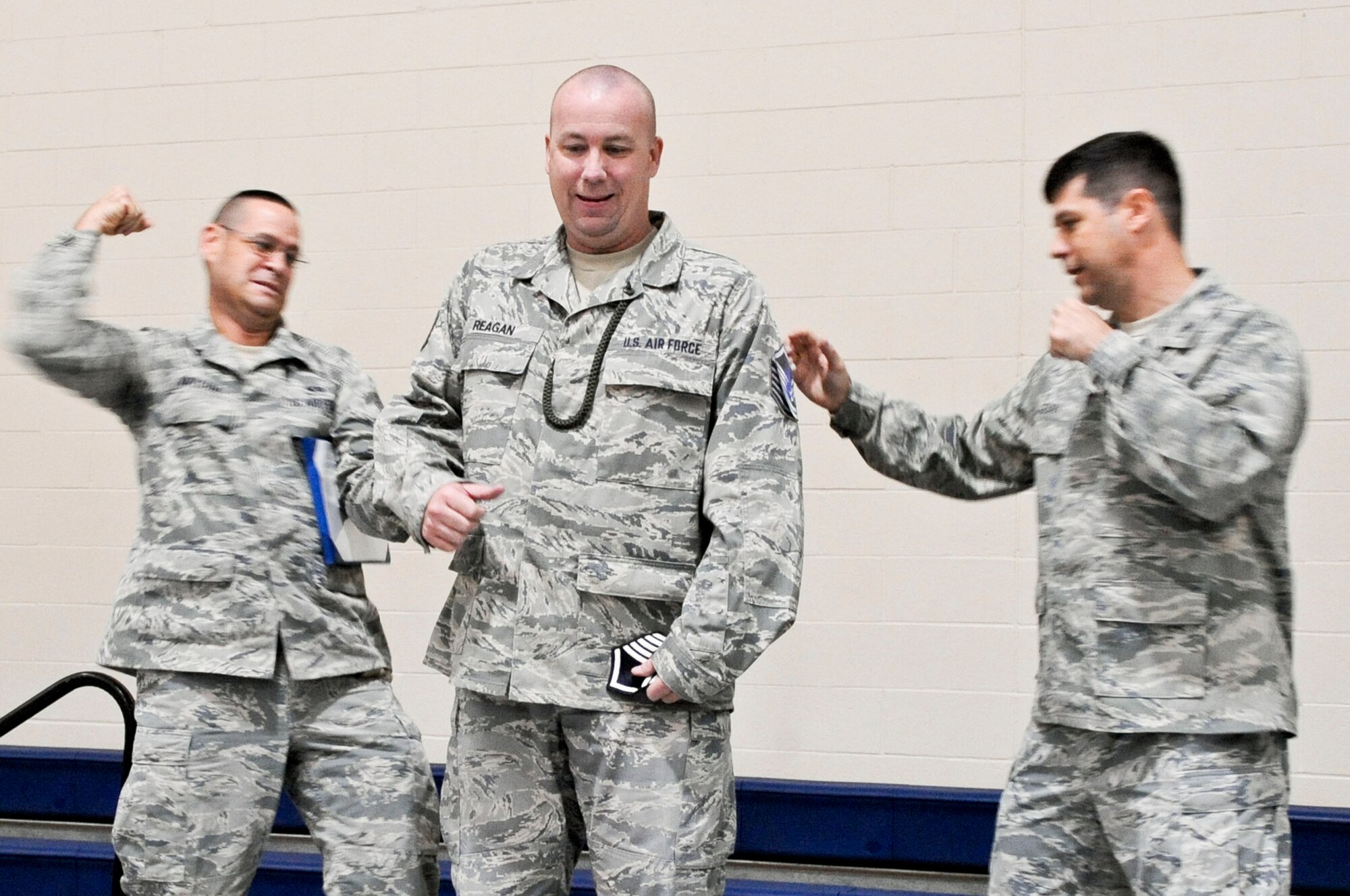Col. Andrew Gebara, 2nd Bomb Wing commander, and Chief Master Sgt. Larry Malcom, 2 BW command chief, tacks master sergeant stripes on Tech. Sgt. John Reagan, 2nd Logistics Readiness Squadron, during a 2nd Mission Support Group formation at the gym on Barksdale Air Force Base, La., Dec. 7.  Reagan was awarded the promotion through the Air Force's Stripes for Exceptional Performers program. The program recognizes Airmen who are role models to their peers, demonstrate leadership, comprehension and above-and-beyond dedication to the mission. (U.S. Air Force photo/Staff Sgt. La'Shanette V. Garrett)

