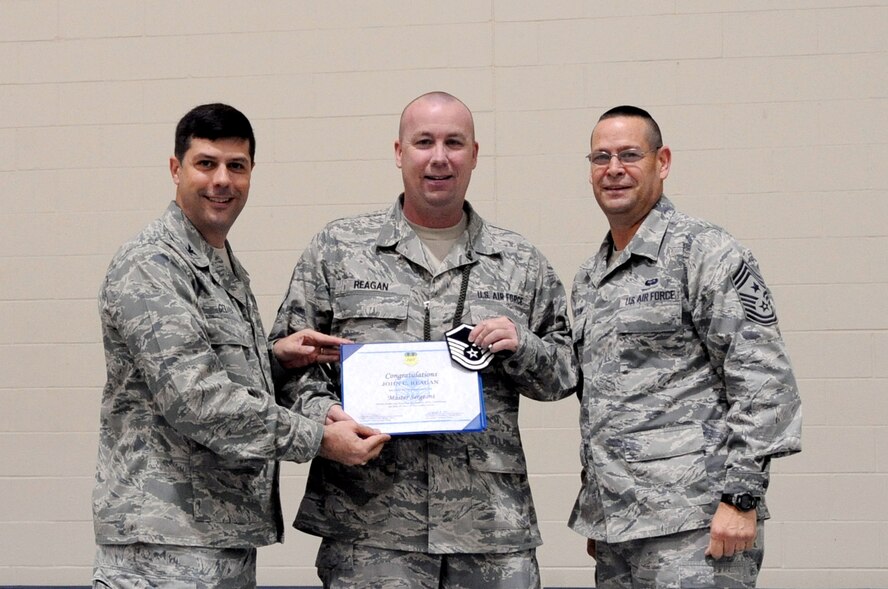Col. Andrew Gebara, 2nd Bomb Wing commander, and Chief Master Sgt. Larry Malcom, 2 BW command chief, presents master sergeant stripes to Tech. Sgt. John Reagan, 2nd Logistics Readiness Squadron, during a recent 2nd Mission Support Group formation at the gym on Barksdale Air Force Base, La., Dec. 7. Reagan was awarded the promotion through the Air Force's Stripes for Exceptional Performers program. The program recognizes Airmen who are role models to their peers, demonstrate leadership, comprehension and above-and-beyond dedication to the mission. (U.S. Air Force photo/Staff Sgt. La'Shanette V. Garrett)
