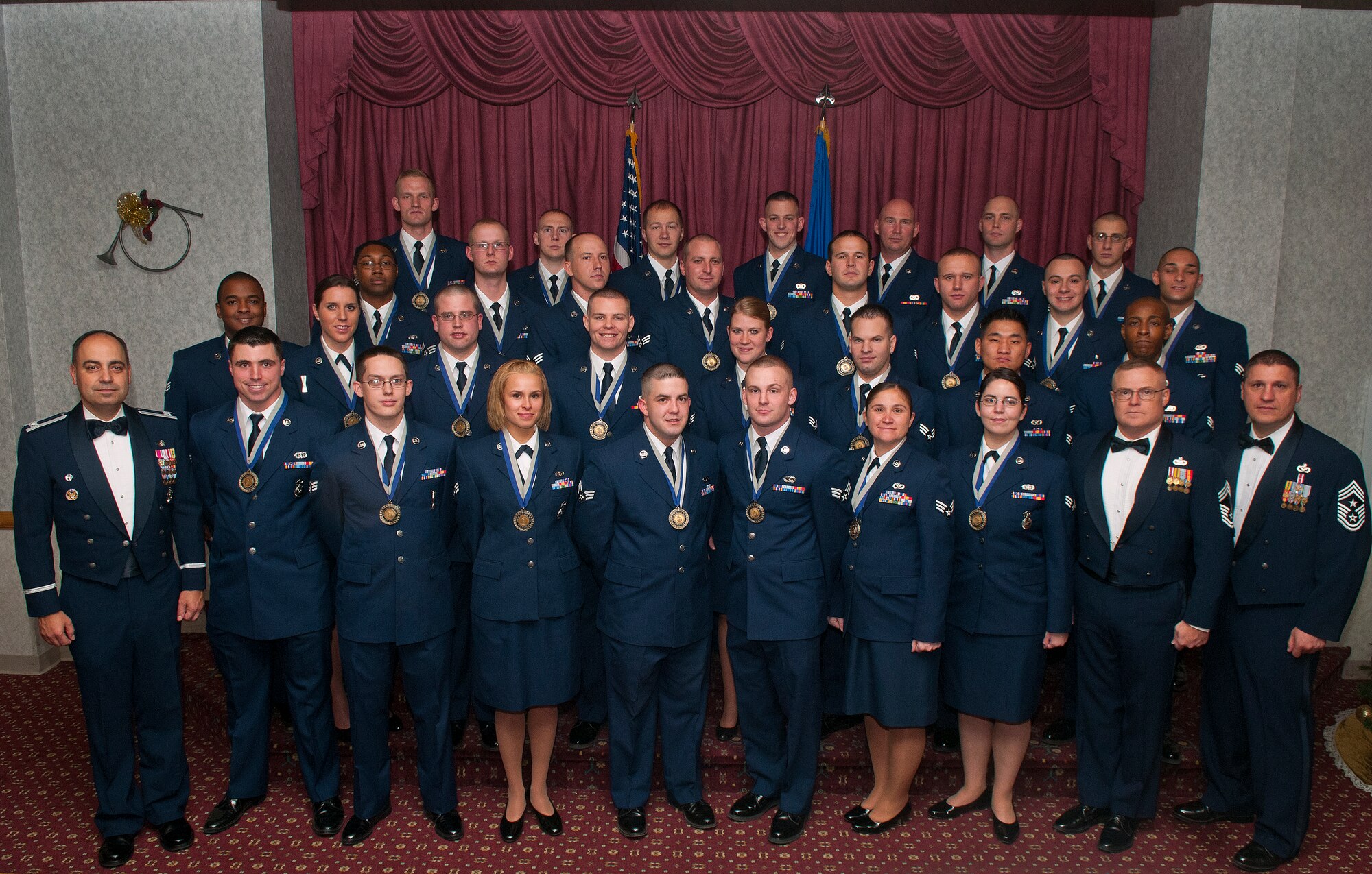 Col. George Farfour, 90th Missile Wing vice commander; Chief Master Sgt. Justin Banks, guest speaker from the 90th Security Forces Squadron; and Chief Master Sgt. Michael Garrou, 90th Missile Wing chief, pose with Airman Leadership School Class 13-A before their graduation dinner Nov. 29 at the Trail’s End Club on F. E. Warren Air Force Base. (U.S. Air Force photo by R.J. Oriez)