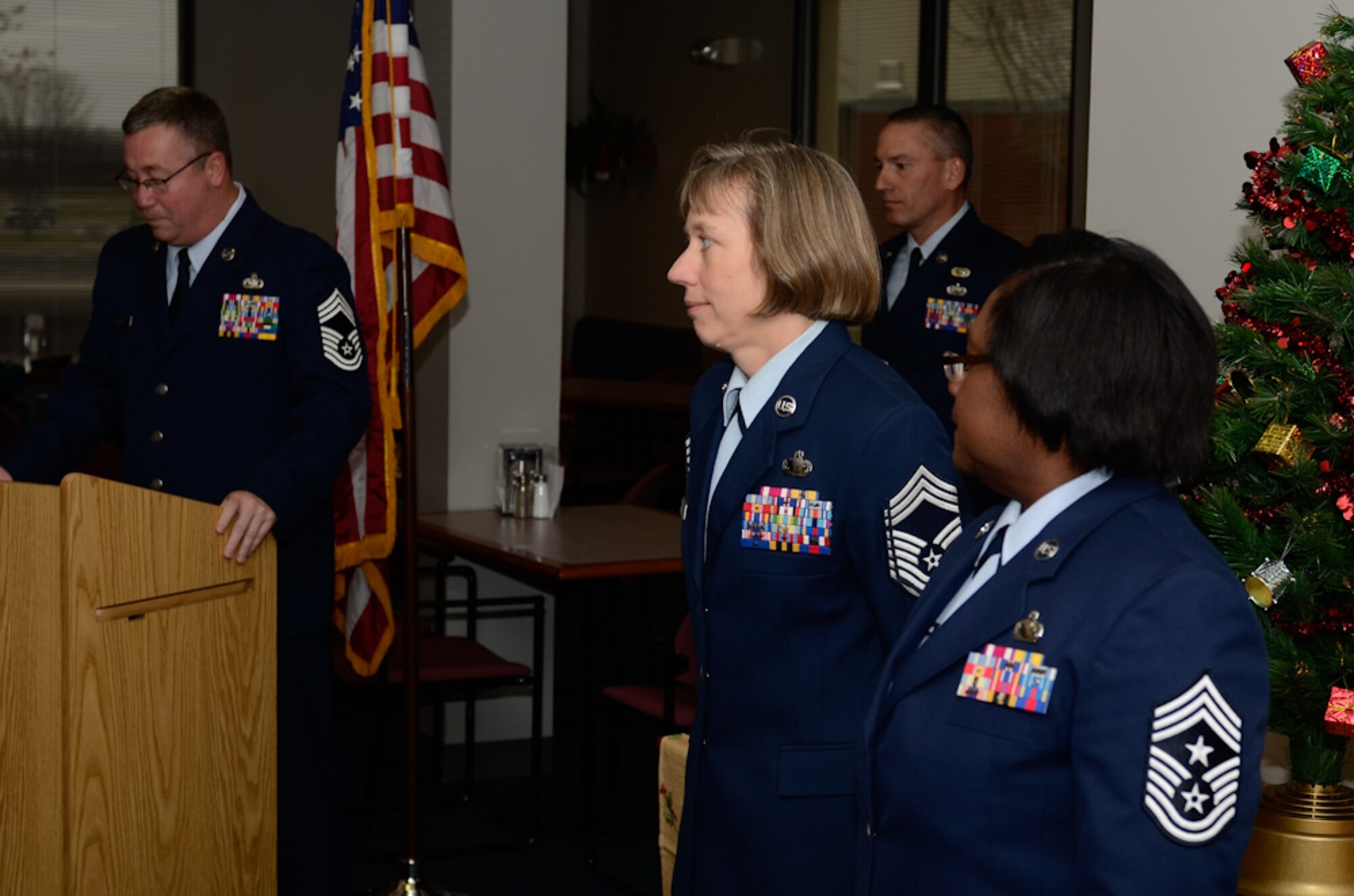 Newly promoted Chief Master Sgt. Barbara DeJoode stands at attention during her promotion ceremony at Rosecrans Air National Guard Base, St. Joseph, Mo., Dec. 7, 2012.