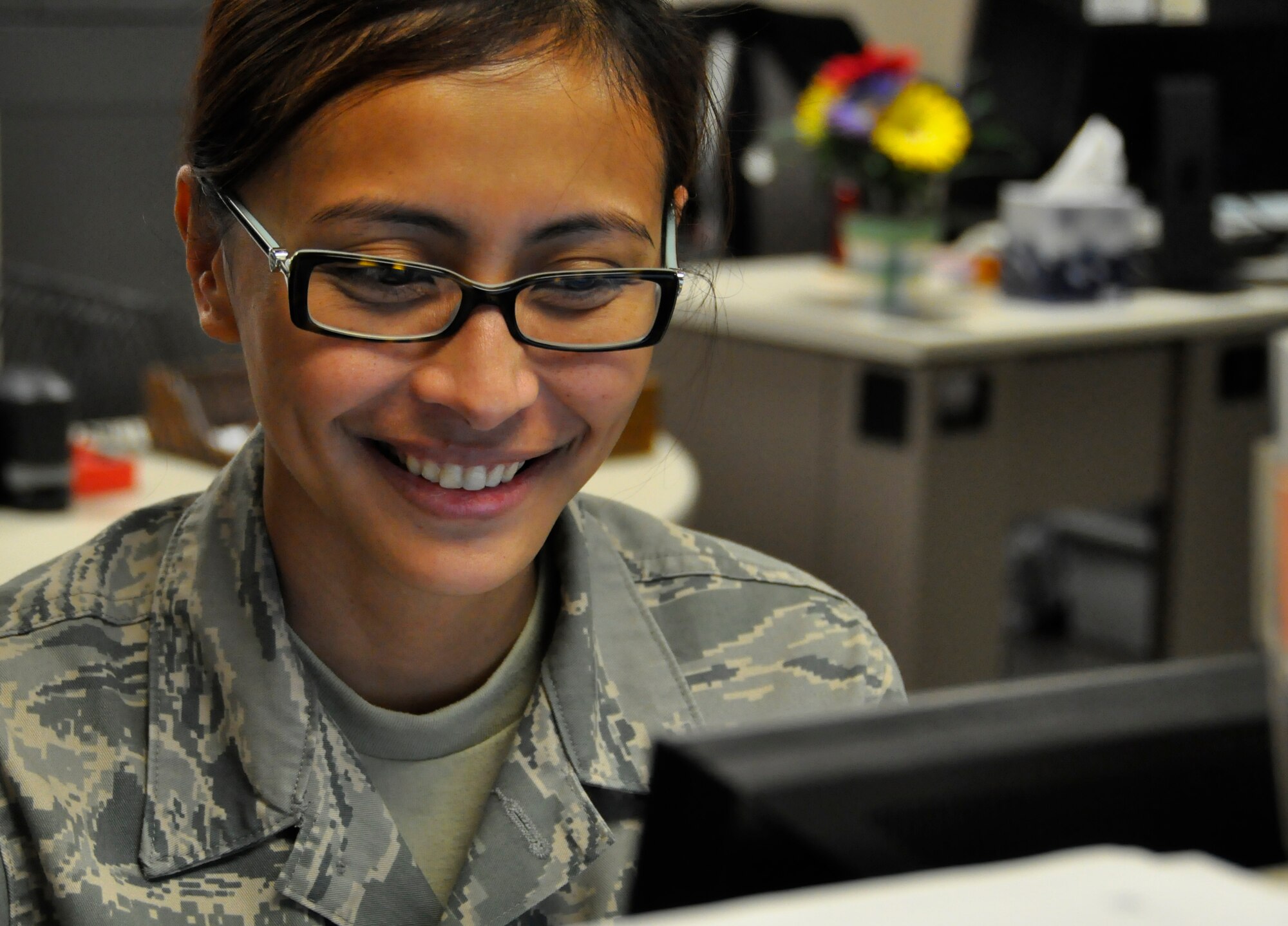 Staff Sgt. Chustine Minoda, a 446th Force Support Squadron education and training apprentice, works on inputting information into the Air Force Virtual Education Center for 446th Airlift Wing Reservists on McChord Field Dec. 1. Minoda recently retrained into education and training from health administrative management. The Education and Training Flight is looking for three traditional Reservists to join their team. (U.S. Air Force photo/Staff Sgt. Rachael Garneau)