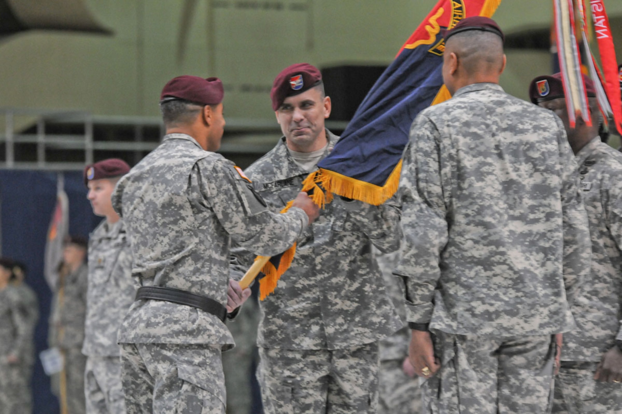 U.S. Army Alaska Commanding General Maj. Gen. Michael Garrett passes the unit colors of the 4th Brigade Combat Team (Airborne), 25th Infantry Division to the incoming commander Col. Matthew McFarlane during a change of command ceremony at JBER on Wednesday. (U.S. Army photo/Sgt. 1st Class Jason Epperson)