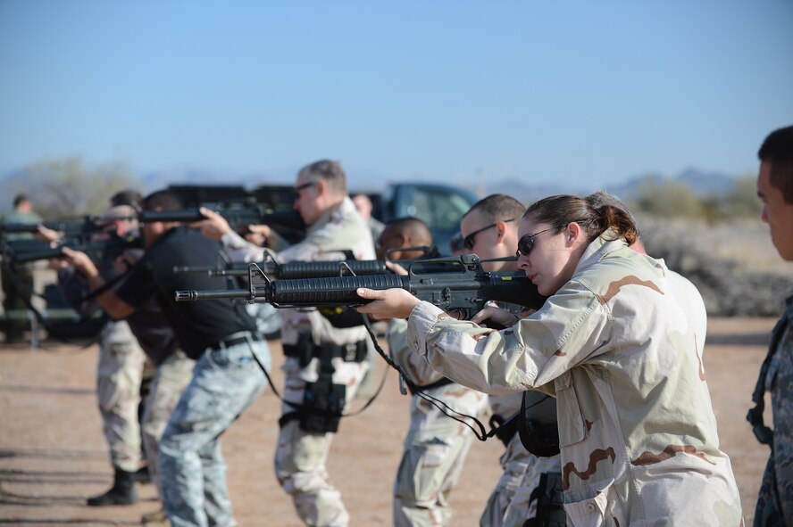 Department of the Air Force police officers practice aiming at targets during the shoot, move and communicate training exercise at the Auxiliary field on Luke Air Force Base, Ariz., Nov. 28, 2012. DAF police are required to stay proficient and qualified on the weapons that they use for base security. (U.S. Air Force photo by Staff Sgt. Jason Colbert)