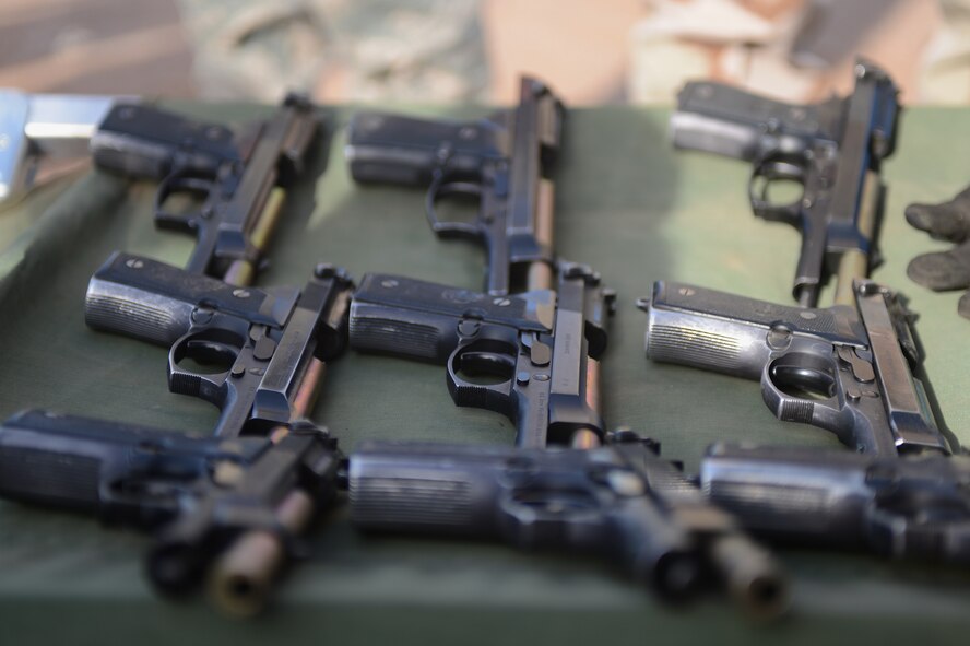 M-9 Berretta pistols sit ready for use by the Department of the Air Force police officers during the shoot, move and communicate training exercise at Luke Air Force Base, Ariz., Nov. 28, 2012. DAF police are required to complete annual proficiency qualification training on the M-9 pistol. (U.S. Air Force photo by Staff Sgt. Jason Colbert)