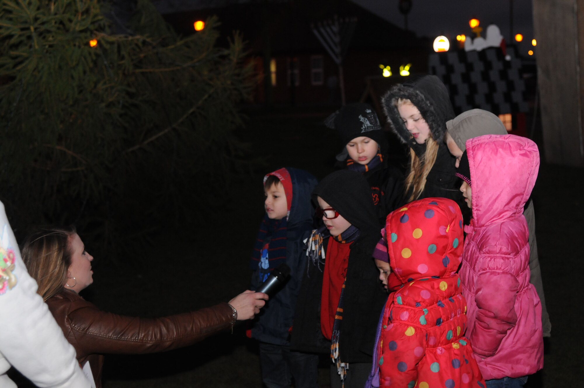 Children sing Christmas carols during the base Christmas tree lighting ceremony Dec. 7, 2012, at RAF Mildenhall, England. The ceremony celebrated the start of the holiday season for RAF Mildenhall. (U.S. Air Force photo by Airman 1st Class Kelsey Waters/Released)