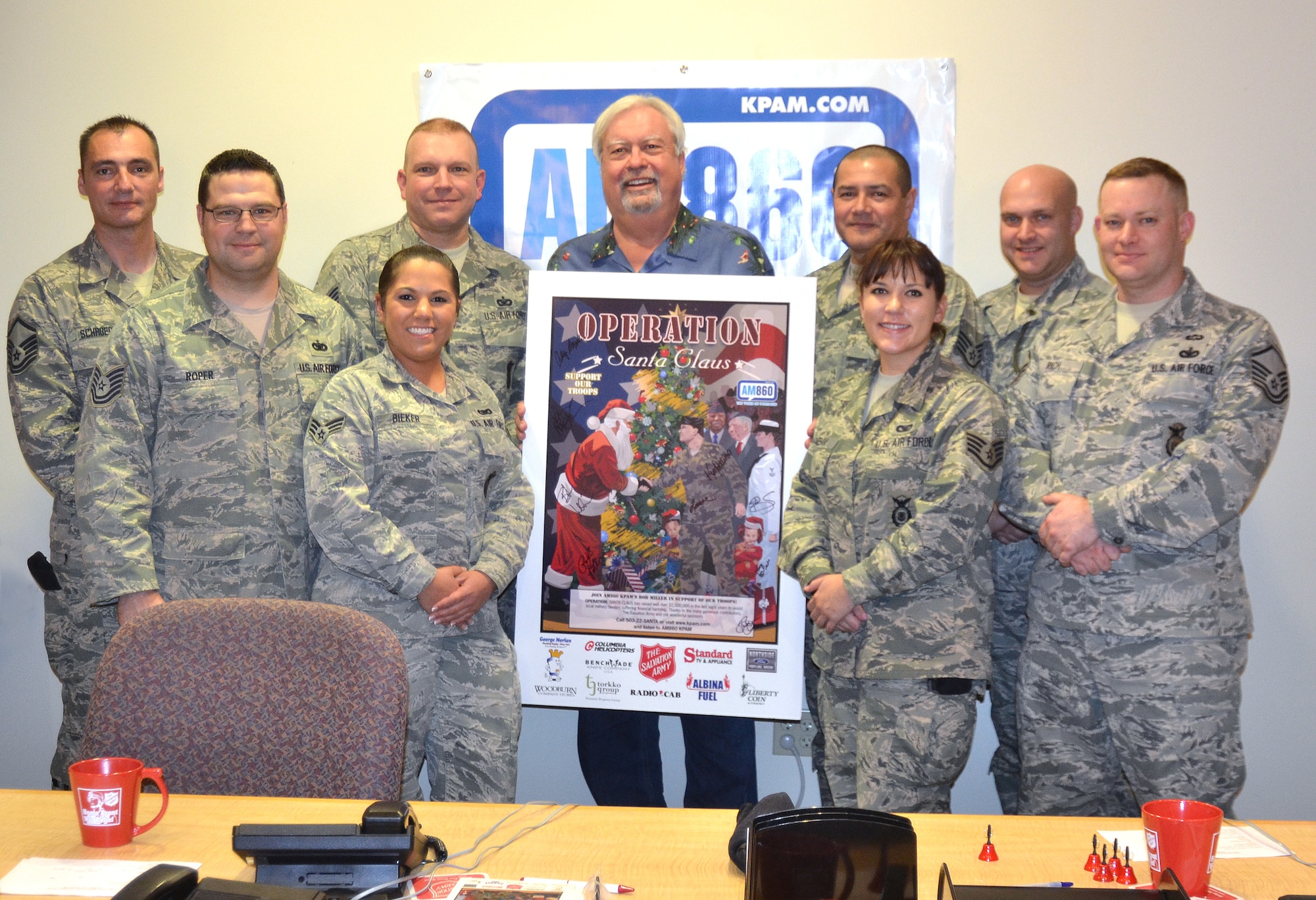 Oregon Air National Guard members of the 142nd Fighter Wing Security Forces Squadron pose for a photograph with Bob Miller, radio host of the Bob Miller Show, during an Off Air break, as part of the Operation Santa Claus fund raising event in Portland, Ore., Nov. 30, 2012. (U.S. Air Force photo by Tech. Sgt. Emily Thompson, 142nd Fighter Wing Public Affairs/Released)