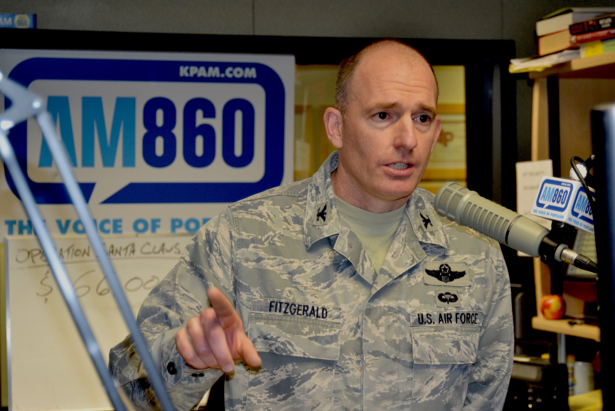 Oregon Air National Guard Col. Paul Fitzgerald, 142nd Fighter Wing Mission Support Commander, answers questions during the Operation Santa Claus fund raising event held on the Bob Miller Show, Nov. 30, 2012 here in Portland, Ore. (U.S. Air Force photo by Tech. Sgt. Emily Thompson, 142nd Fighter Wing Public Affairs/Released)