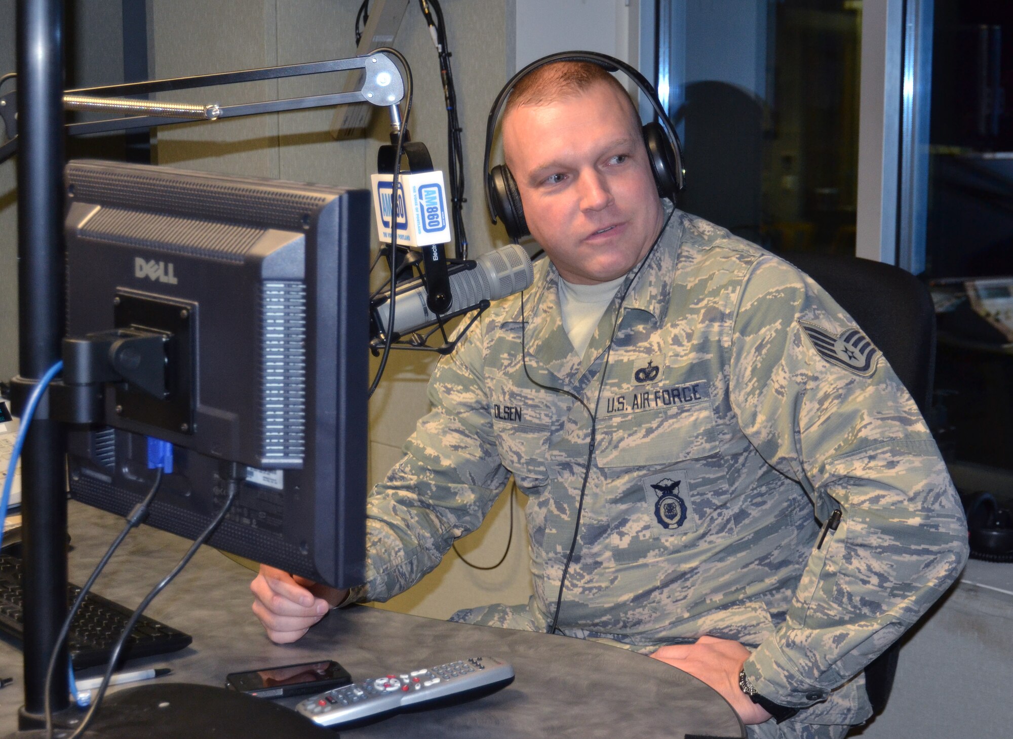 Oregon Air National Guard Staff Sgt. Kylan Olsen, 142nd Fighter Wing Security Forces Squadron, is interviewed live on the radio during the Bob Miller Show, as part of Operation Santa Claus, here in Portland, Ore., Nov. 30, 2012. (U.S. Air Force photo by Tech. Sgt. Emily Thompson, 142nd Fighter Wing Public Affairs/Released)