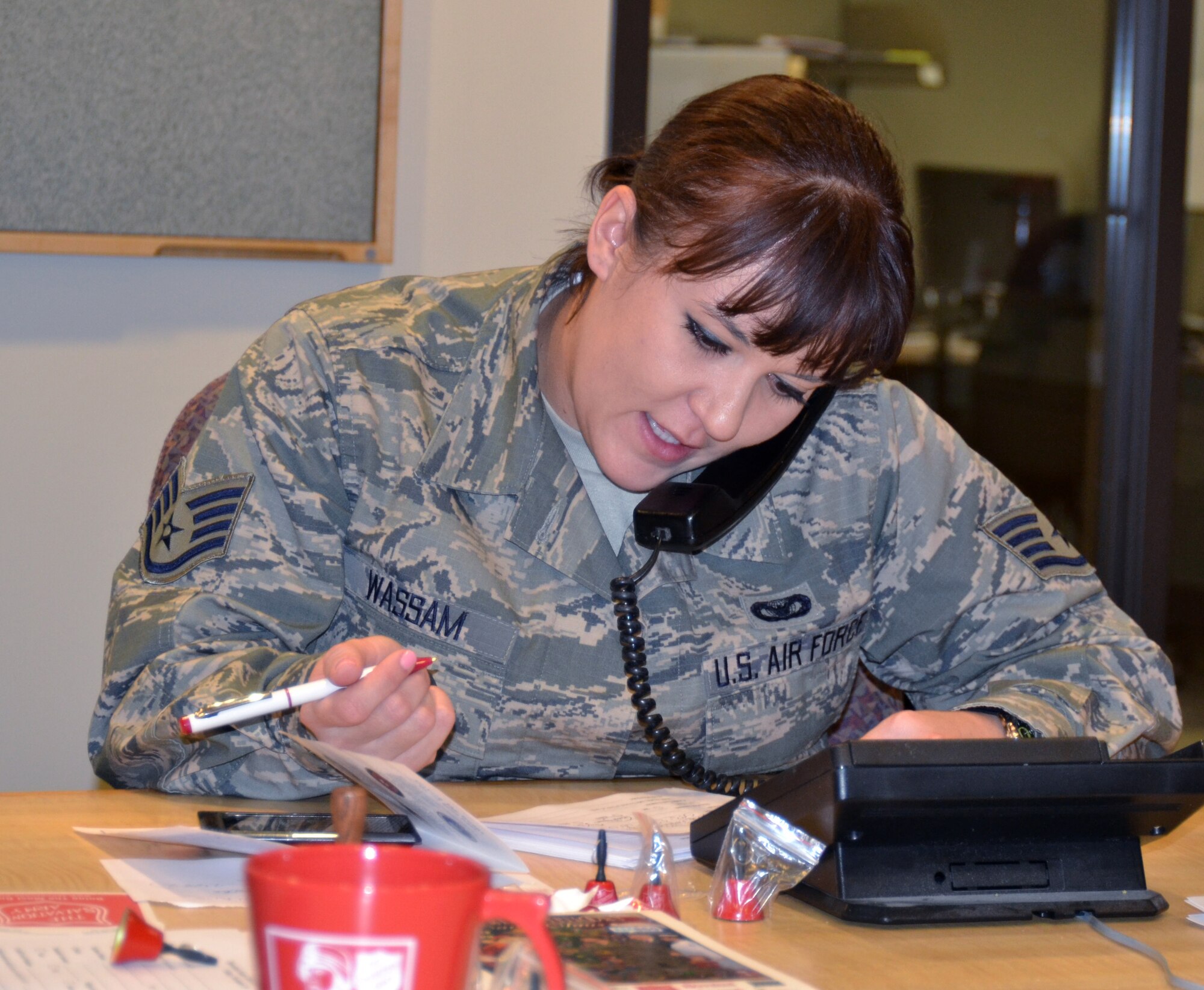 Oregon Air National Guard Staff Sgt. Sara Wassam, 142nd Fighter Wing Security Forces Squadron, takes a fund raising pledge over the phone as part of the Operation Santa Claus, during the Bob Miller Show on KAMP, AM-860 radio, here in Portland, Ore., Nov. 30, 2012. (U.S. Air Force photo by Tech. Sgt. Emily Thompson, 142nd Fighter Wing Public Affairs/Released)