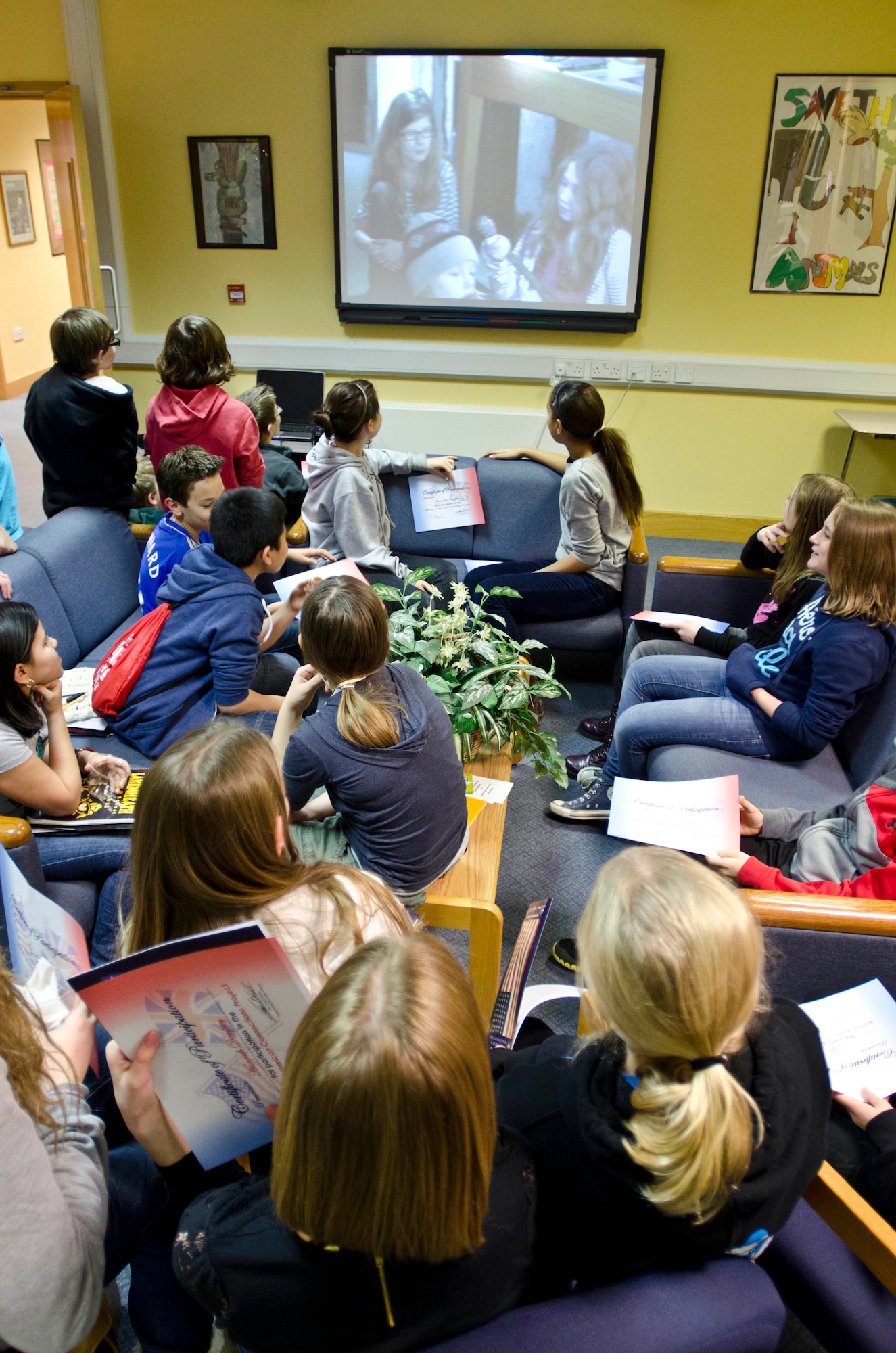 ROYAL AIR FORCE FELTWELL, England - Fifth-and-sixth-grade students watch a slideshow of the work and research they did for the Connecting People: Norfolk's American Connections exhibit at Lakenheath Middle School Dec. 5, 2012. More than 150 children, ages 7-12, from 10 schools worked on the exhibit in early 2012. Approximately 25,000 people viewed the exhibit across 120 venues in Norfolk. (U.S. Air Force photo by Staff Sgt. Stephen Linch)