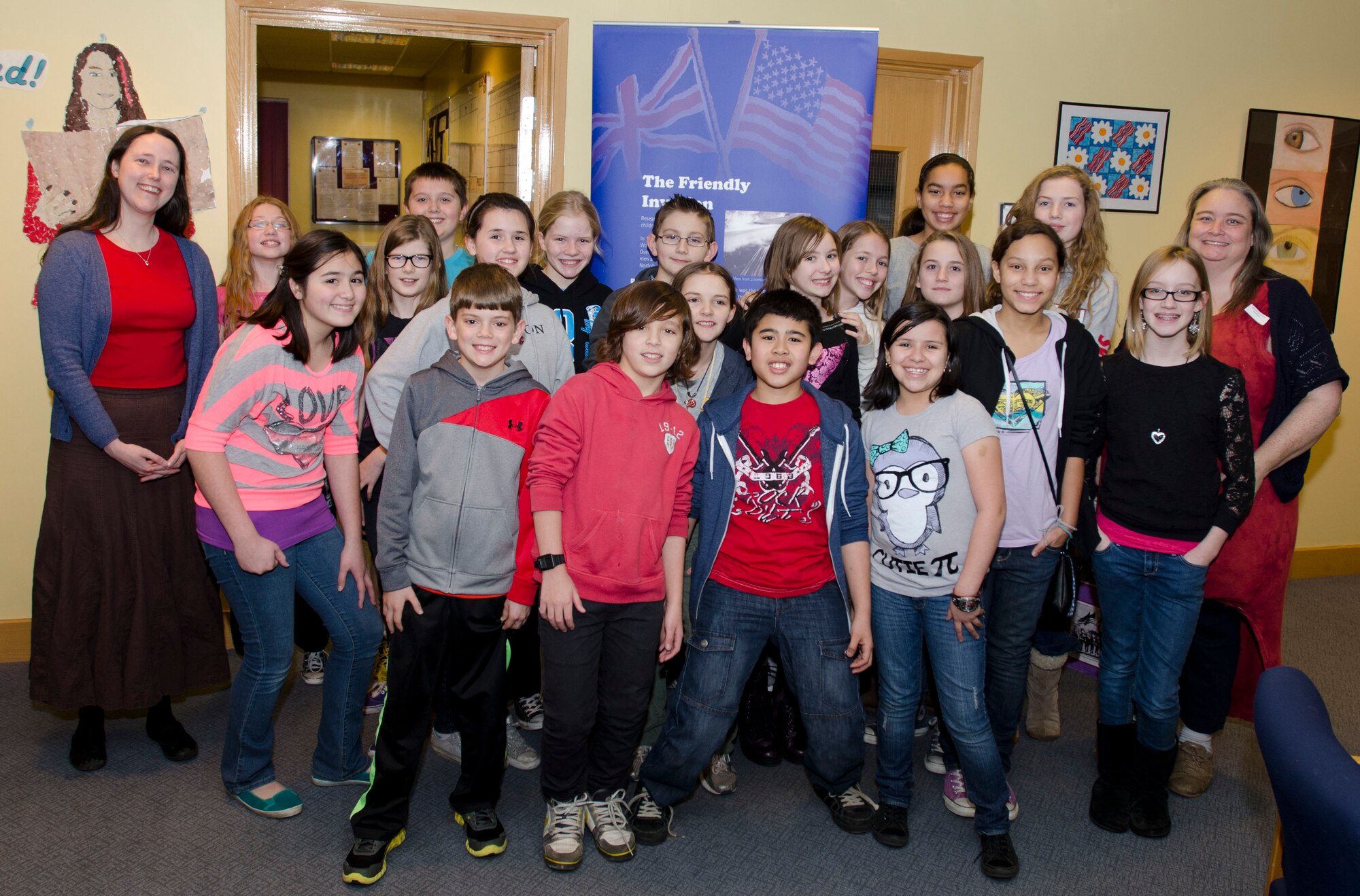 ROYAL AIR FORCE FELTWELL, England - Melissa Hawker (left), Norfolk Museum and Archeology Service learning officer, and Randi Dalton (right), Lakenheath Intermediate School gifted teacher, pose for a photo with students who worked on The Friendly Invasion display for the Connecting People: Norfolk's American Connections exhibit at Lakenheath Middle School Dec. 5, 2012. More than 150 children, ages 7-12, from 10 schools worked on the exhibit in early 2012. Approximately 25,000 people viewed the exhibit across 120 venues in Norfolk.  (U.S. Air Force photo by Staff Sgt. Stephen Linch)