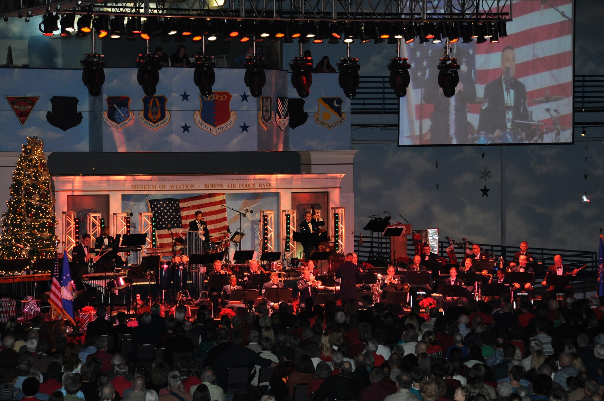 An overflow crowd enjoys the Band of the U.S. Air Force Reserve performance during the 51st Annual Holiday Concert at the Museum of Aviation at Robins Air Force Base, Dec. 6 (U.S. Air Force photo/Philip Rhodes)