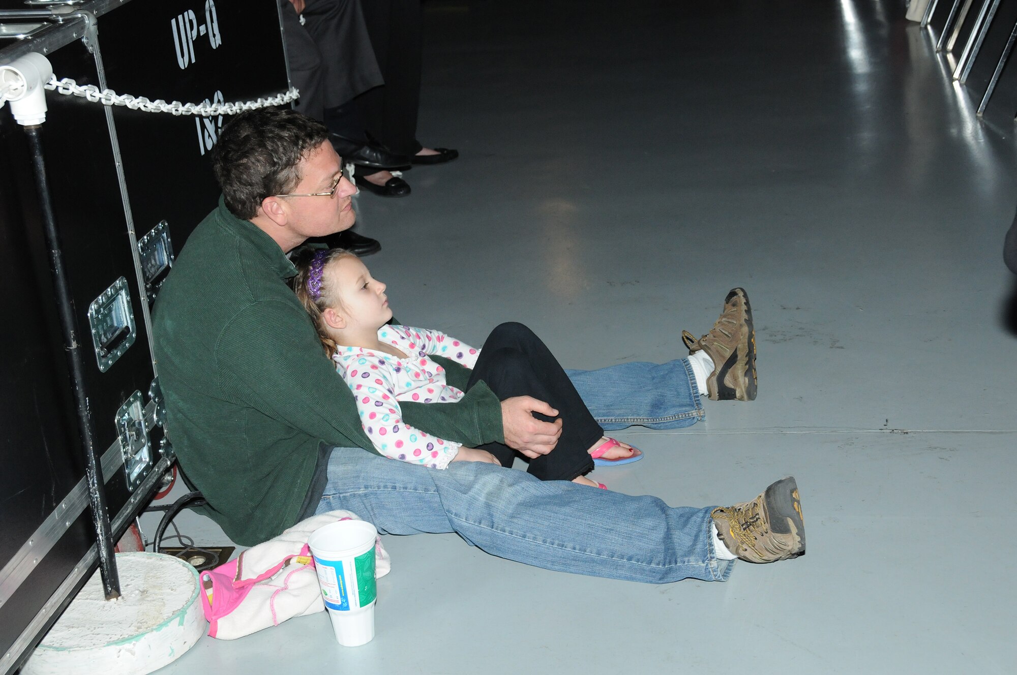 It was standing room only at the 51st Annual Holiday Concert at the Museum of Aviation at Robins Air Force Base, Ga., Dec. 6. This father and daughter found a comfortable spot on the floor to listen to the Band of the U.S. Air Force Reserve. (U.S. Air Force photo/Philip Rhodes)