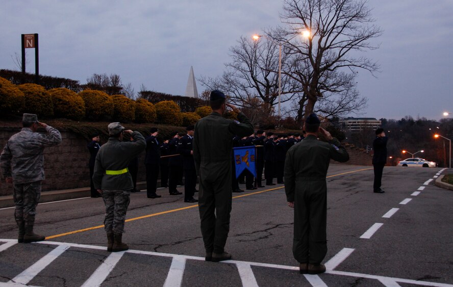 Command Chief Master Sgt.  John E. Payne; 911th Maintenance Group Commander Col. Rebecca A. Oroukin; Commander of the 911th Airlift Wing Col. Craig C. Peters; and Vice Commander  of the 911th AW Col. Jeffrey S. Kozak,  take up spots on the crosswalk outside of Headquarters for reveille here Dec. 1, 2012. Lt. Col. John G. Bojanac directs his squadron of security force personnel for the reveille detail and the last morning as the Security Forces Squadron Commander. Bojanac recently accepted a position at Robbins Air Force Base, Ga. Members of Bojanac’s squadron don their Air Force blues in honor of his loyal time and service at the 911th. (U.S. Air Force photo by Senior Airman Justyne Obeldobel / Released)