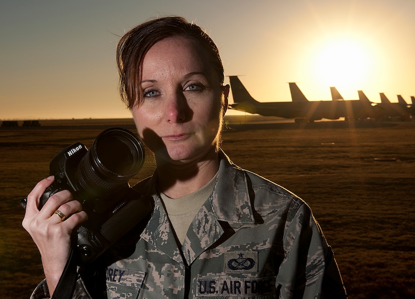 Master Sgt. Rebecca Corey holds her most important tool, the camera, at the flightline on Altus Air Force Base, Okla., Dec. 6, 20120. After her 2009 deployment to Ghazni province, Afghanistan, as a combat photographer, Corey struggled with life-altering post-traumatic stress disorder. Today, she is the NCO in charge at the 97th Air Mobility Wing. (U.S. Air Force photo/) 
