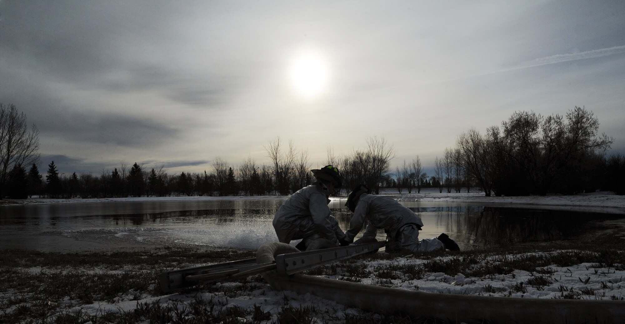 MINOT AIR FORCE BASE, N.D. – Fire Fighters from the 5th Civil Engineering Squadron add another layer of water to one of the new ice skating rinks here, Nov. 28. There will be three ice skating rink located on base. (U.S. Air Force photo/Senior Airman Brittany Y. Auld)