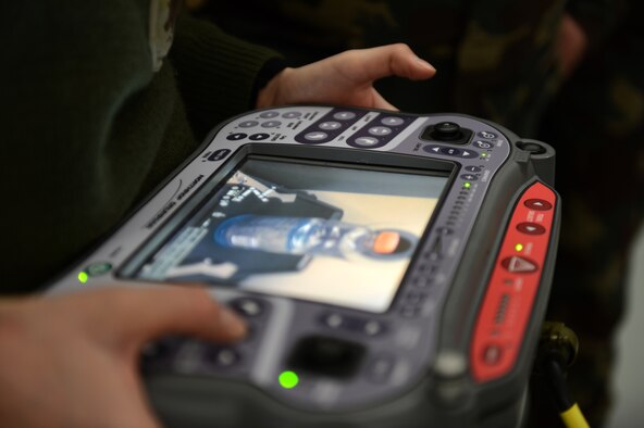 SPANGDAHLEM AIR BASE, Germany – Hungarian army Sgt. Agnes Pinter, Hungarian Defense Force NCO Academy counter IED instructor, views the screen of a Remotec HD-2 remote control military robot at the 52nd Civil Engineer Squadron Explosive Ordnance Disposal shop Dec. 4, 2012. Hungarian army members visited Spangdahlem Air Base to join forces in teaching information on the most current threats in contingency operations across the globe. The HD-2 is a more versatile and digitally advanced robot than its predecessor. It includes an improved camera mounted on the robot and an all-in-one control with monitoring system that displays clearer quality images. (U.S. Air Force photo by Airman 1st Class Gustavo Castillo/Released)
