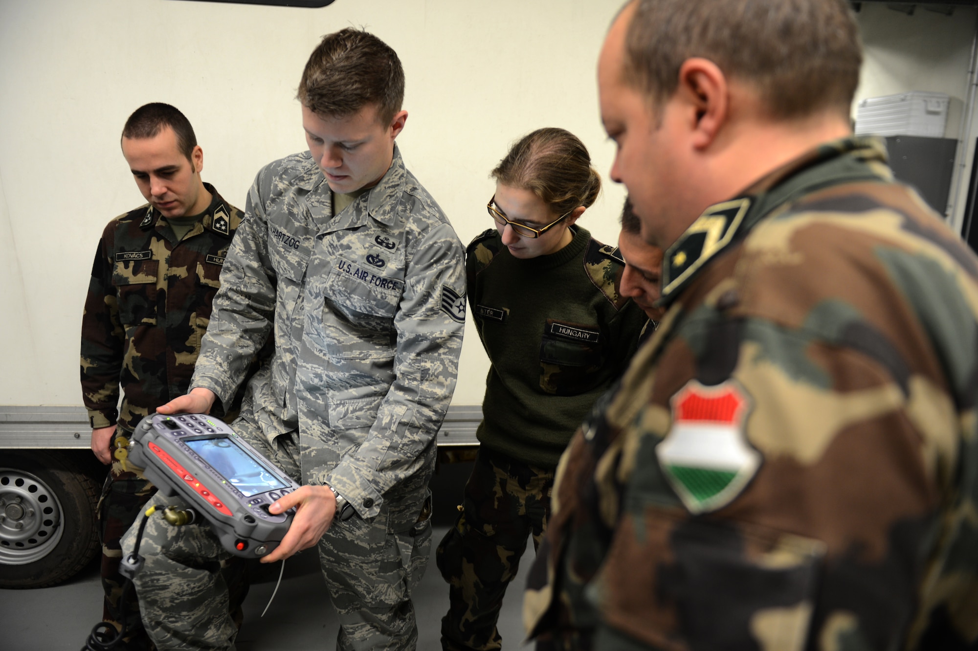 SPANGDAHLEM AIR BASE, Germany – U.S. Air Force Staff Sgt. Paul Hartzog, 52nd Civil Engineer Squadron Explosive Ordnance Disposal technician from Buford, Ga., trains members of the Hungarian army on how to operate a Remotec HD-2 remote control military robot at the EOD shop Dec. 4, 2012.  Hungarian army members visited Spangdahlem Air Base to join forces in teaching information on the most current threats in contingency operations across the globe. Unmanned vehicles like the HD-2 are used to dispose of ordnance without the risk of injury for the operator. (U.S. Air Force photo by Airman 1st Class Gustavo Castillo/Released)  