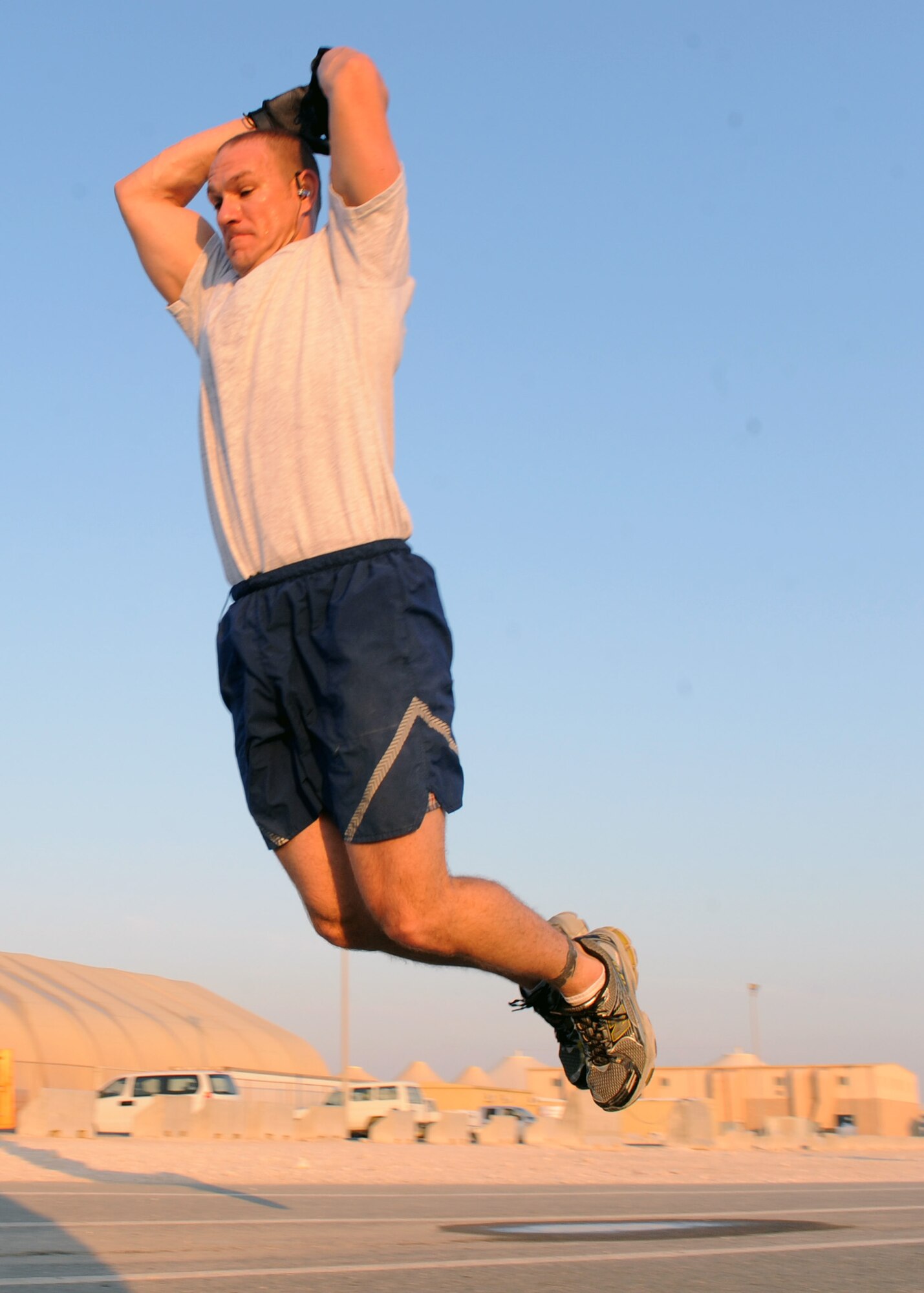 SOUTHWEST ASIA – Maj. Brad Boudreaux, 609th Air Communications Squadron Detachment 1 director of operations, takes flight during the extreme burpee challenge Dec. 1. To break the monotony of a deployment, the squadron has come up with extreme fitness challenges for their Airmen to participate in. Bodreaux finished all four laps in 2 hours, 9 minutes and 44 seconds. (Not pictured) Staff Sgt. Aaron Morrill, 609th ACOMS Det. 1, placed second with a time of 1 hour, 40 minutes and 42 seconds. (U.S. Air Force photo/Senior Airman Joel Mease)