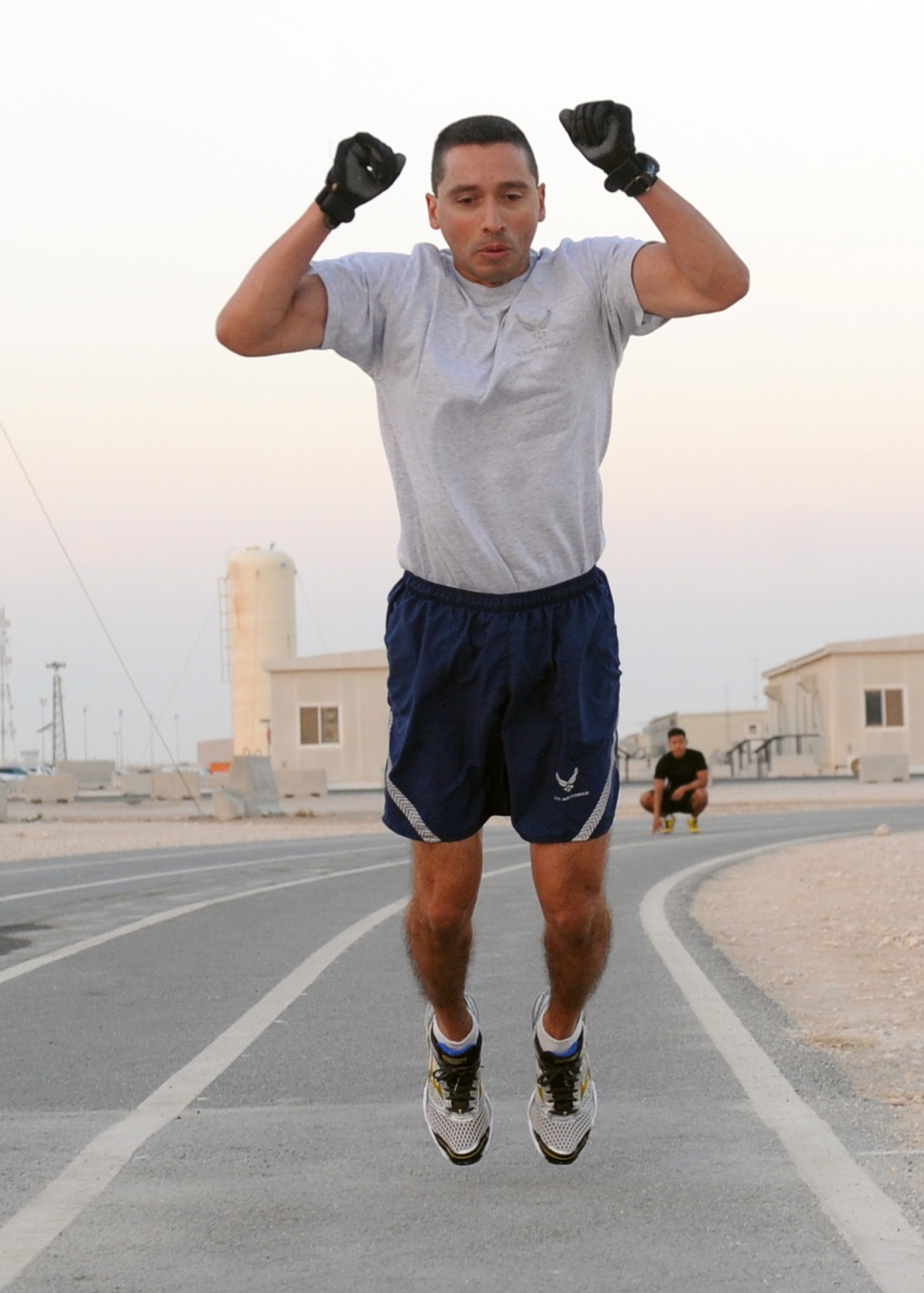 SOUTHWEST ASIA – Lt. Col. Joseph Terrones, 609th Air Communications Squadron Detachment 1 commander, leads his Airmen during the extreme burpee challenge Dec. 1. Terrones finished in third place with a time of 1 hour, 44 minutes and 49 seconds. Only four Airmen completed the entire mile during the challenge, but everyone was able to at least complete one lap around the track. It was estimated it would take approximately 220 burpees to complete one lap around the track – if the Airman had a decent leap forward. (U.S. Air Force photo/Senior Airman Joel Mease)