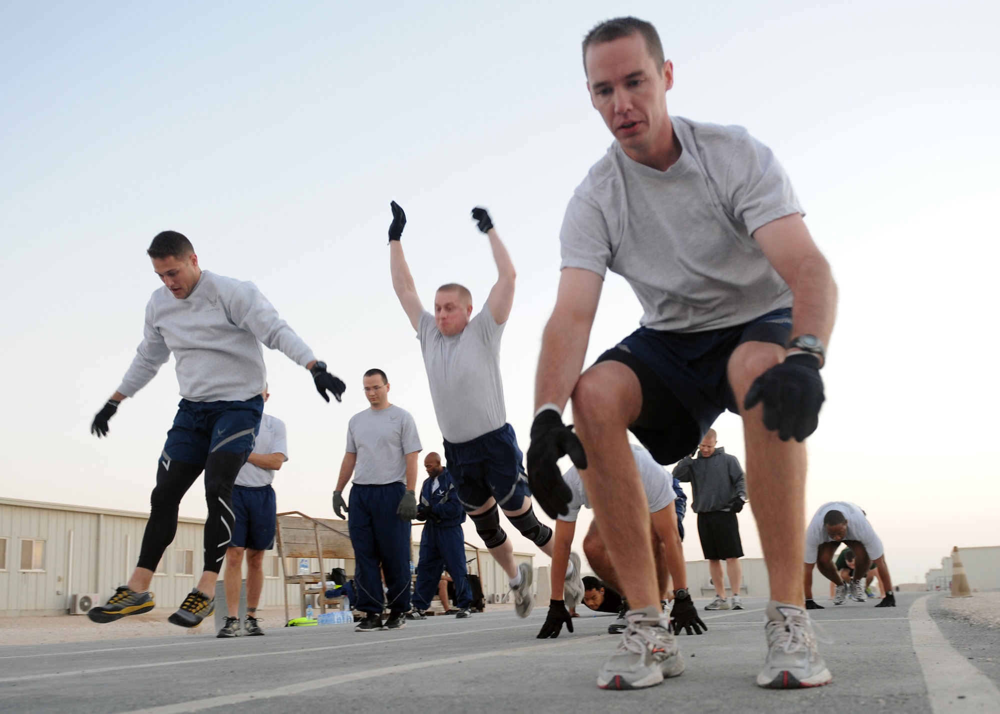 SOUTHWEST ASIA – Airmen from the 609th Air Communications Squadron Detachment 1 start the extreme burpee challenge Dec. 1. The challenge was to complete a mile of burpees around the 379th Air Expeditionary Wing track. One burpee consists of doing a complete pushup, then jump up while leaping forward and repeat the process. (U.S. Air Force photo/Senior Airman Joel Mease)