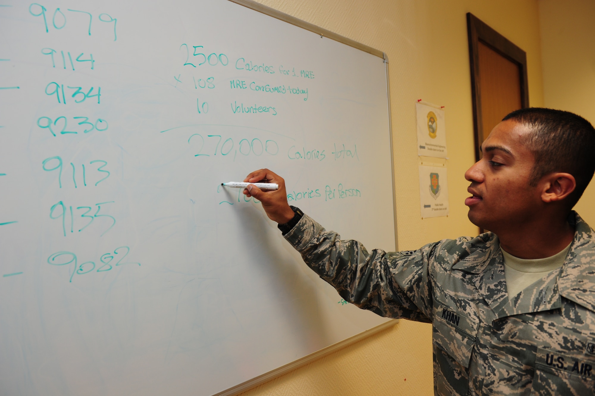 SOUTHWEST ASIA -- Senior Airman Husein Khan, 379th Expeditionary Medical Group Public Heath technician, calculates the potential calories consumed by the Meals Ready to Eat inspectors during Operation: Chowdown. If the volunteer inspectors had eaten everything in each of the 10 MREs during the quarterly inpection, they would have eaten 27,000 calories. (U.S. Air Force photo/ Master Sgt Brendan Kavanaugh)