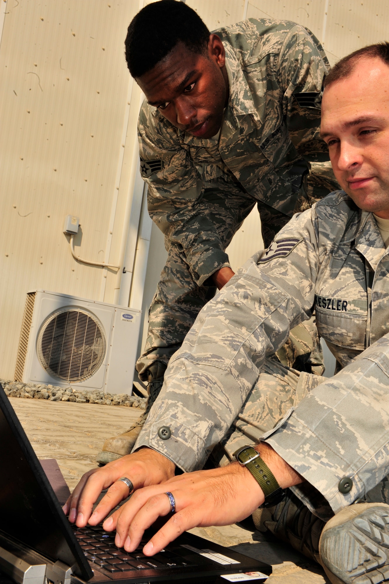 SOUTHWEST ASIA -- U.S. Air Force Staff Sgt. Bradley Keszler and Senior Airman Garrett Rhodes, 380th Expeditionary Communications Squadron radio frequency transmissions system technicians, configure the Communications Fly-Away Kit (CFK) Nov. 3, 2012. Communications personnel demonstrate their ability to set-up the Non-Secure Internet Protocol Router, Secure Internet Protocol Router, and Voice Over Secure Internet Protocol within 30 minutes during emergencies and contingency operations. (U.S. Air Force photo/Tech. Sgt. Christina M. Styer) (RELEASED)