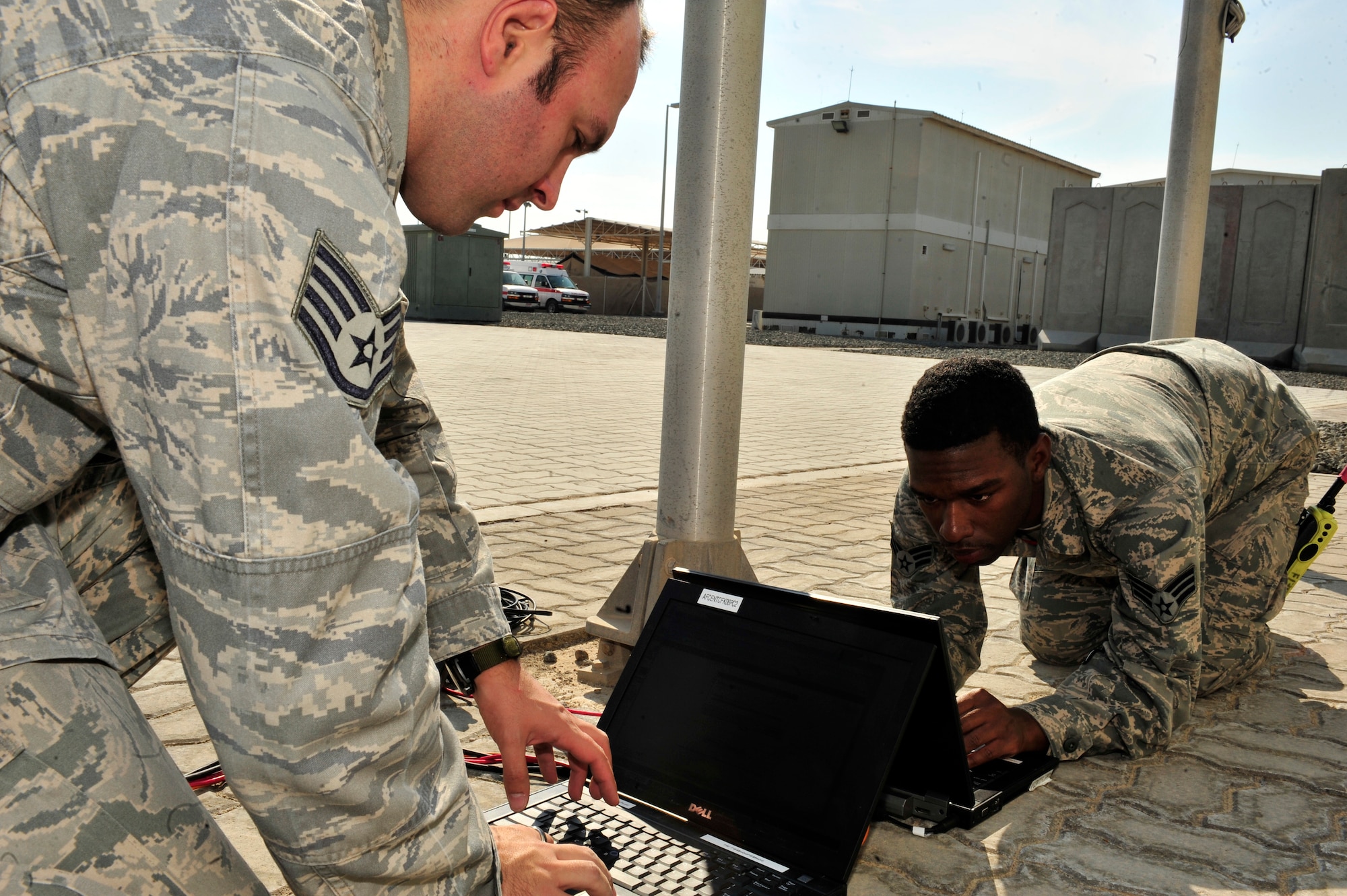 SOUTHWEST ASIA -- U.S. Air Force Staff Sgt. Bradley Keszler and Senior Airman Garrett Rhodes, 380th Expeditionary Communications Squadron radio frequency transmissions system technicians, participate in a weekly operations check of the Communications Fly-Away Kit (CFK) Nov. 3, 2012. Communications personnel are required to demonstrate their ability to provide Non-Secure Internet Protocol Router, Secure Internet Protocol Router, and Voice Over Secure Internet Protocol access weekly. (U.S. Air Force photo/Tech. Sgt. Christina M. Styer) (RELEASED)